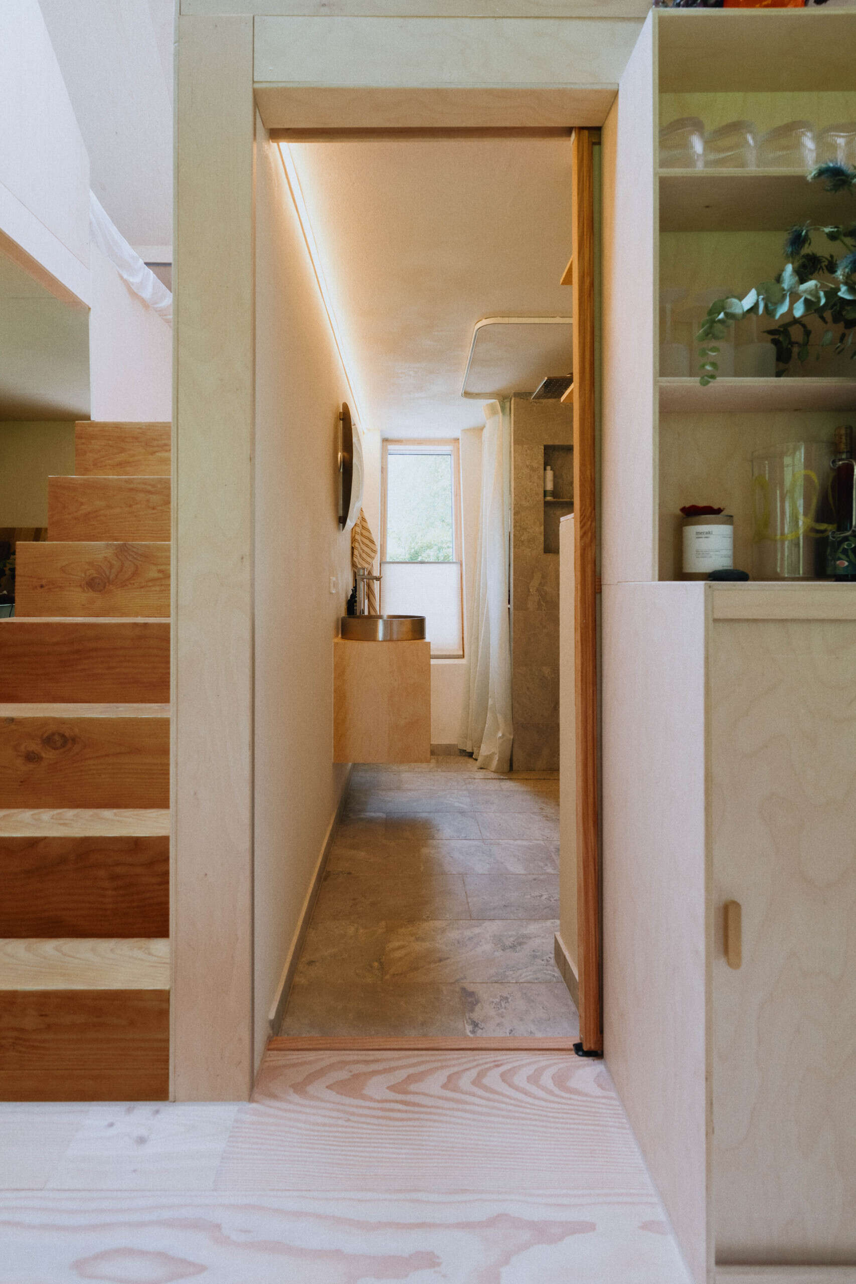 Simple, efficient, and finished with natural materials, EcoNeo's bathroom makes smart use of limited space.