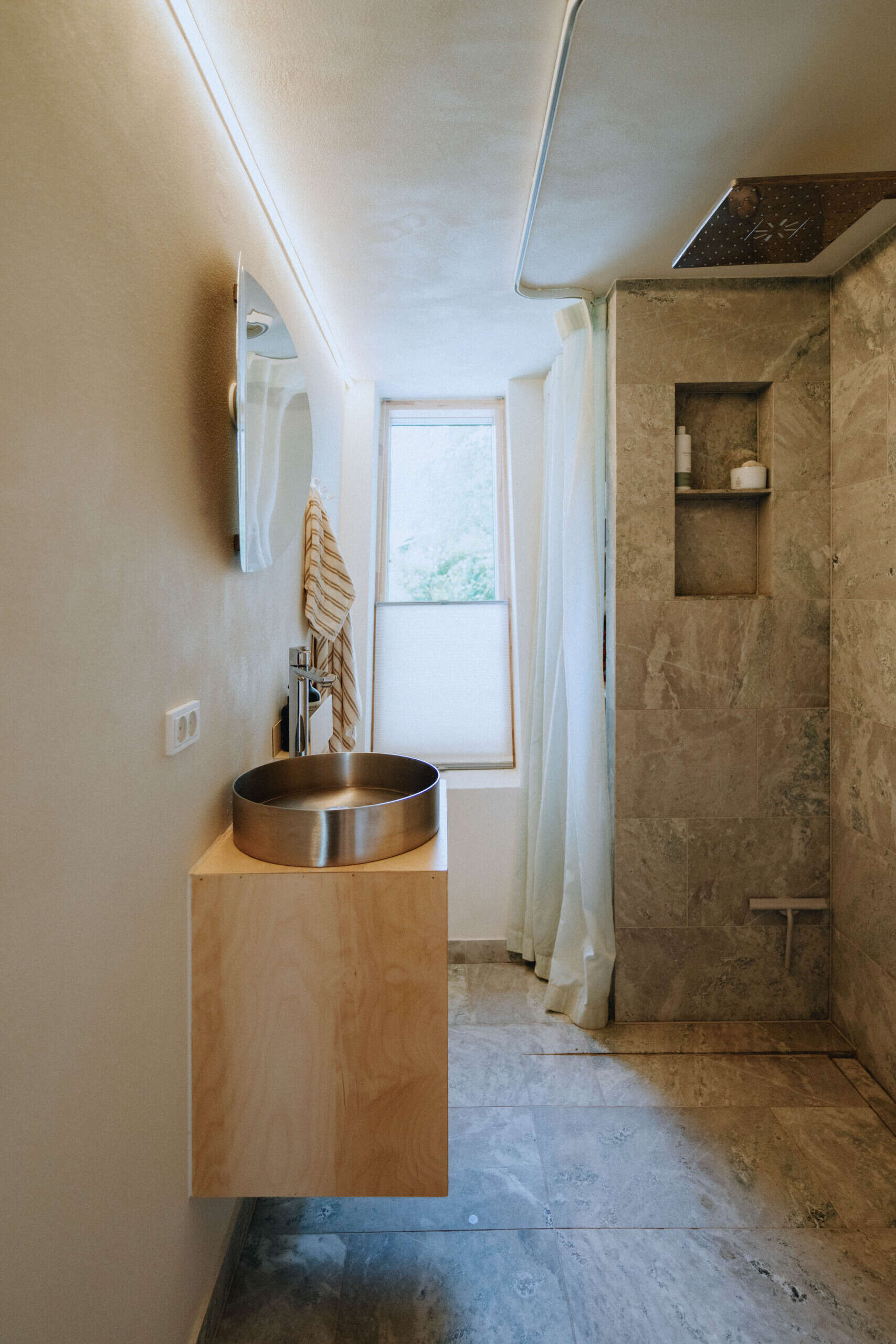 Simple, efficient, and finished with natural materials, EcoNeo's bathroom makes smart use of limited space.