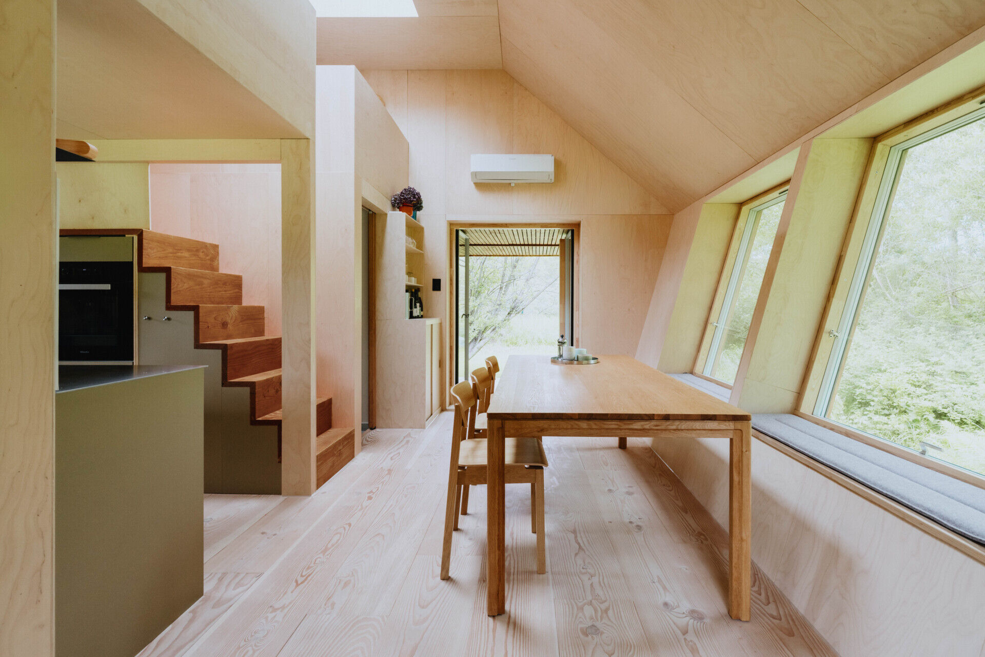 A compact living room that comfortably seats ten people proves small homes can still be highly social.