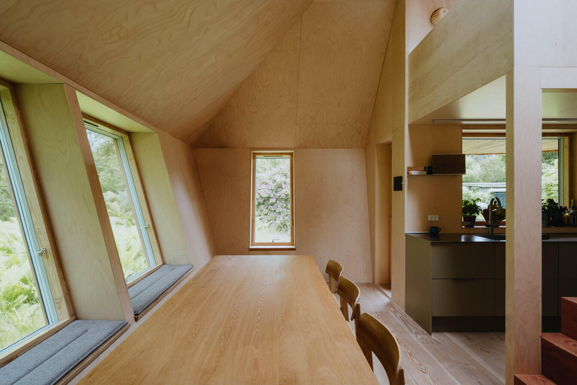A compact living room that comfortably seats ten people proves small homes can still be highly social.