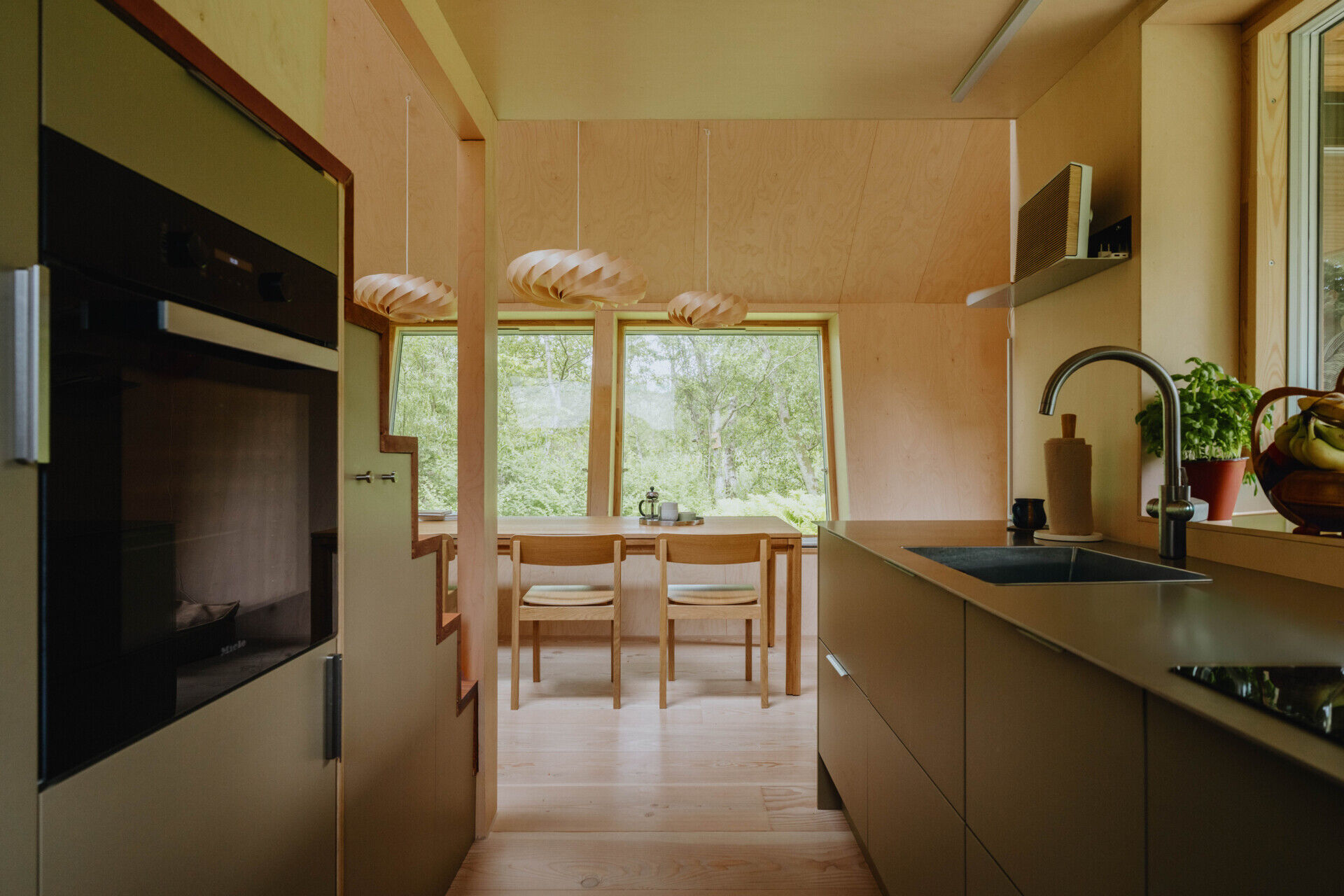 A compact kitchen designed to maximise every centimetre while remaining open to the main living space.