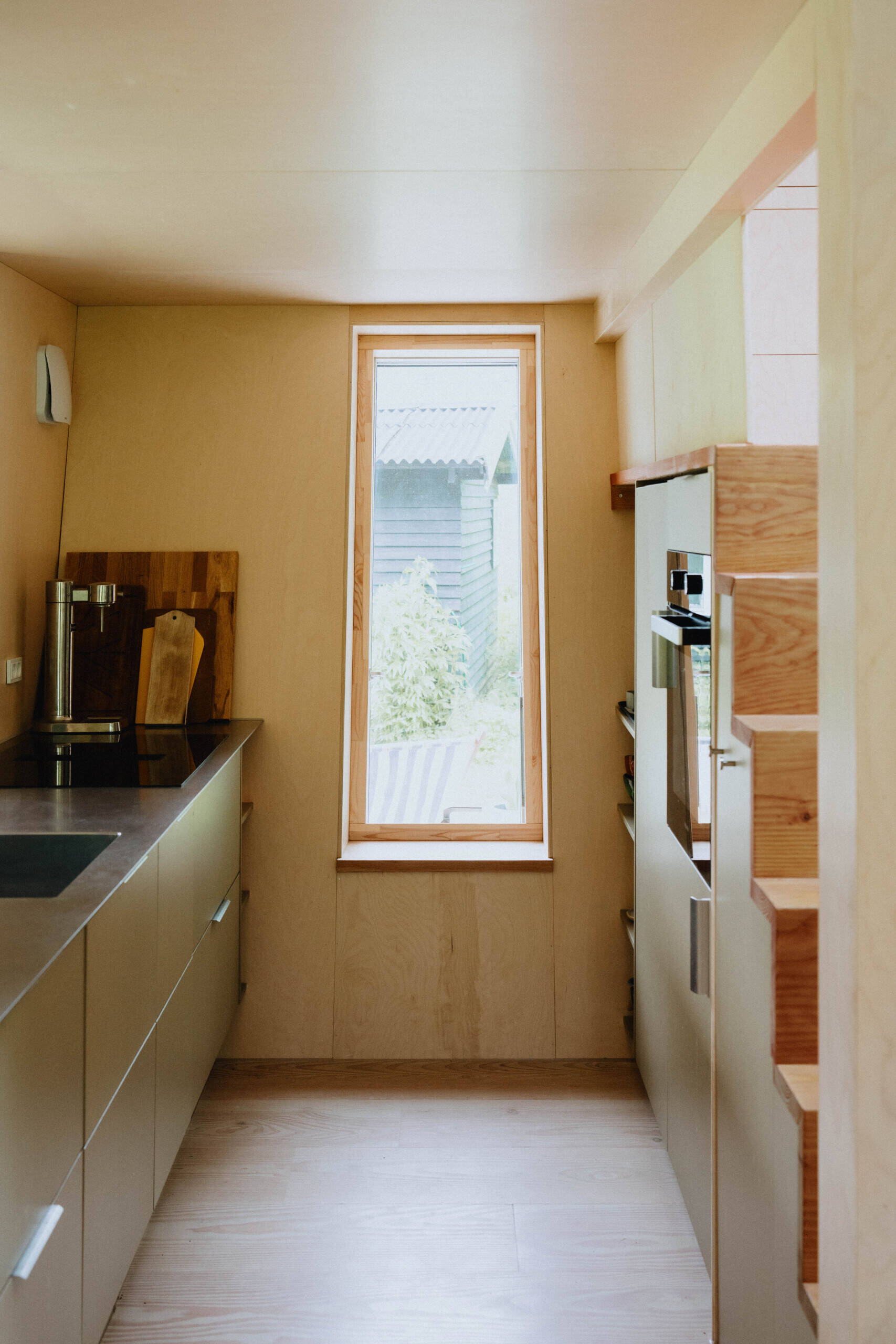 A compact kitchen designed to maximise every centimetre while remaining open to the main living space.
