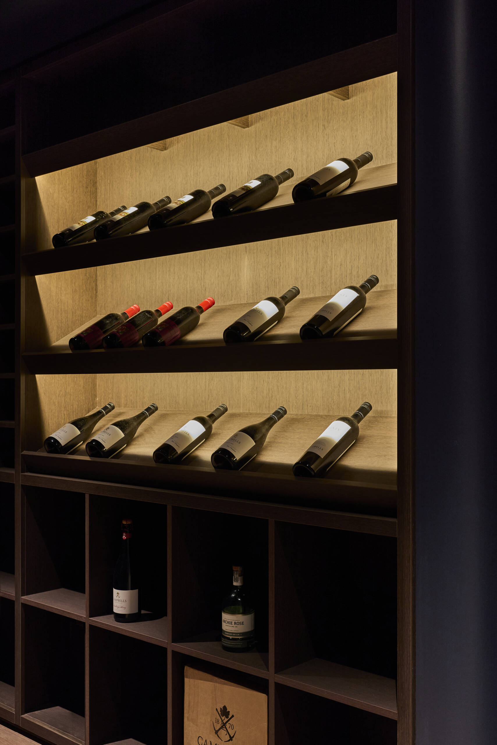 Take a look at the basement wine cellar at Sasso Nero, where darker materials and an enclosed setting create an intimate space that contrasts with the brighter garden-facing rooms above.