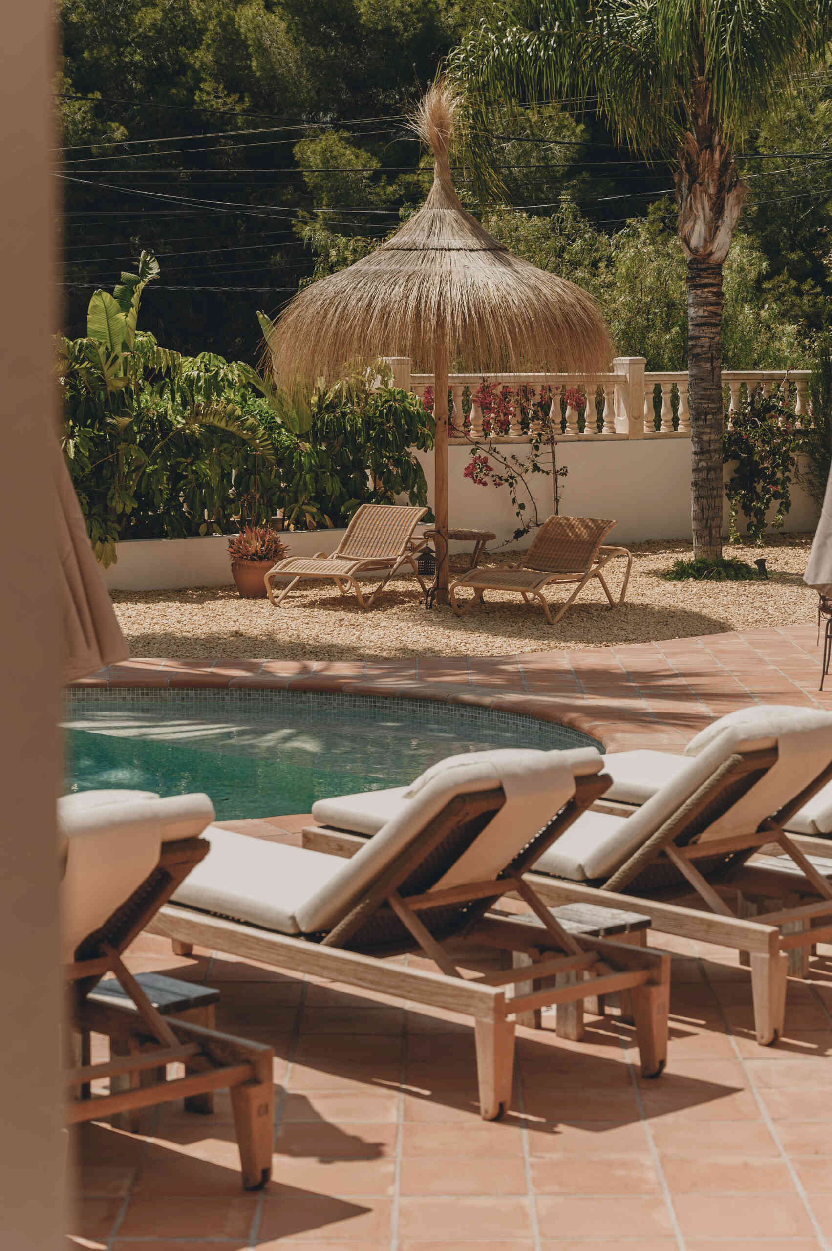 Discover an outdoor dining space and pool that continue the warm Mediterranean feel established throughout the interior.