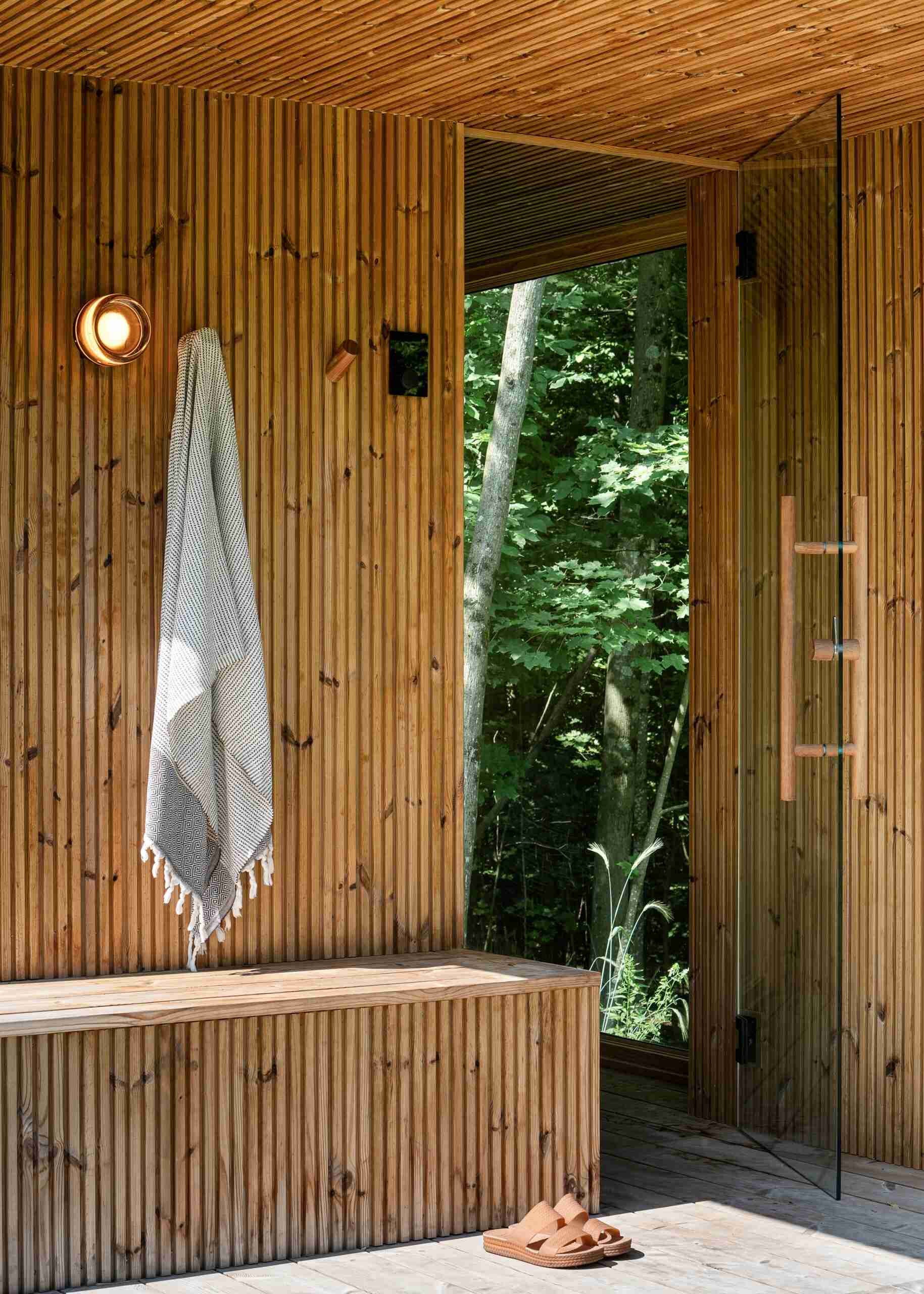 See the detached sauna at the Milo House in Cornwall, Vermont, clad in the same dark yakisugi siding as the main residence and garden shed.