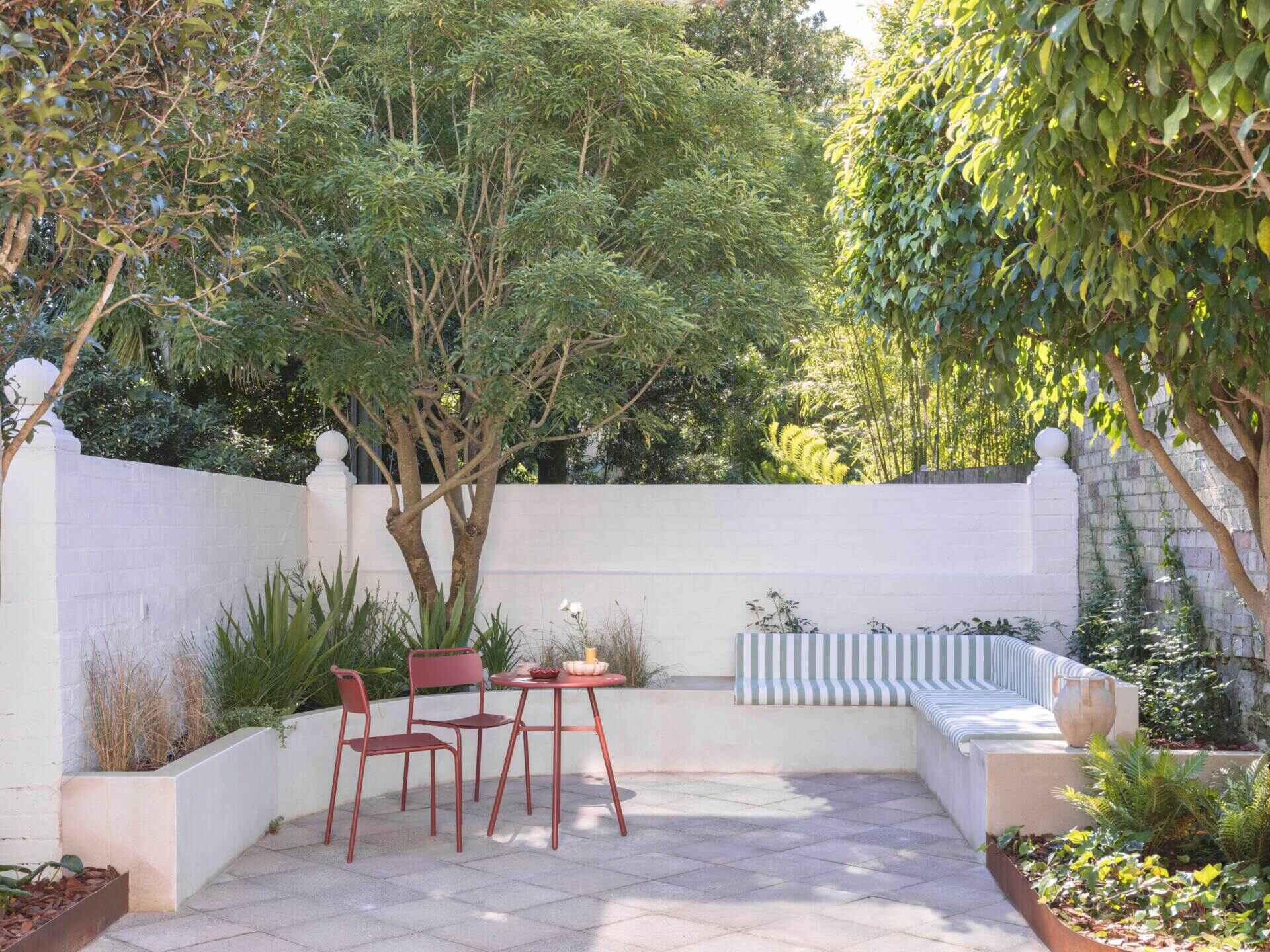 Discover how Noble Architecture transformed an awkward Sydney courtyard into a Modern Mediterranean outdoor space with reclaimed pavers, curved walls, native planting and clever entertaining areas.
