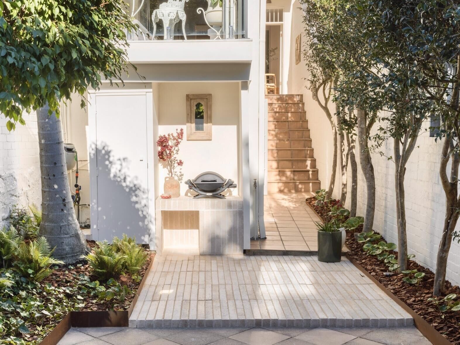 An integrated outdoor kitchen, sustainable hemp-composite bricks and hidden storage make this entertaining area as practical as it is beautiful.