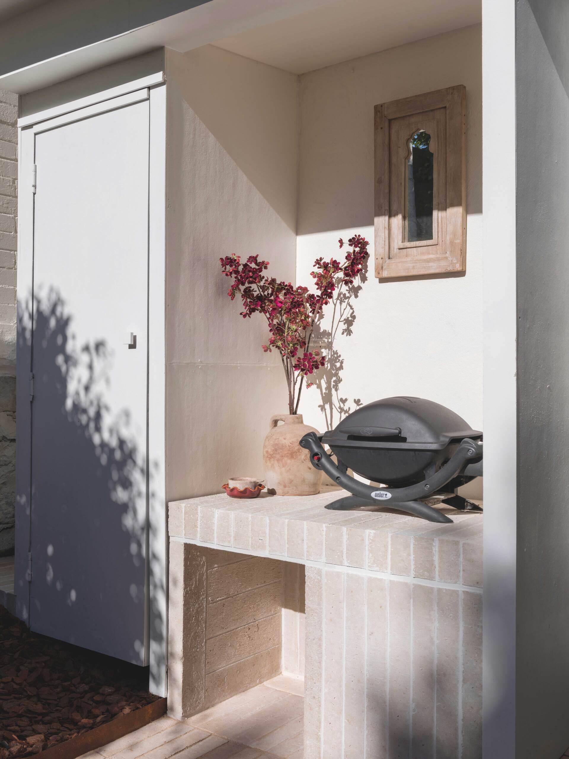 An integrated outdoor kitchen, sustainable hemp-composite bricks and hidden storage make this entertaining area as practical as it is beautiful.