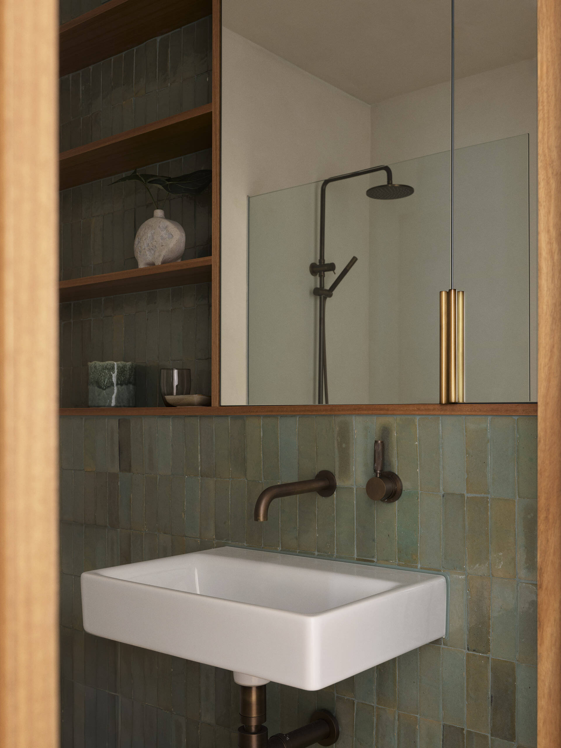Handmade Moroccan tiles bring texture, depth and variation to this Byron Bay guest bathroom, paired with natural brass and earthy finishes for a warm, relaxed interior.