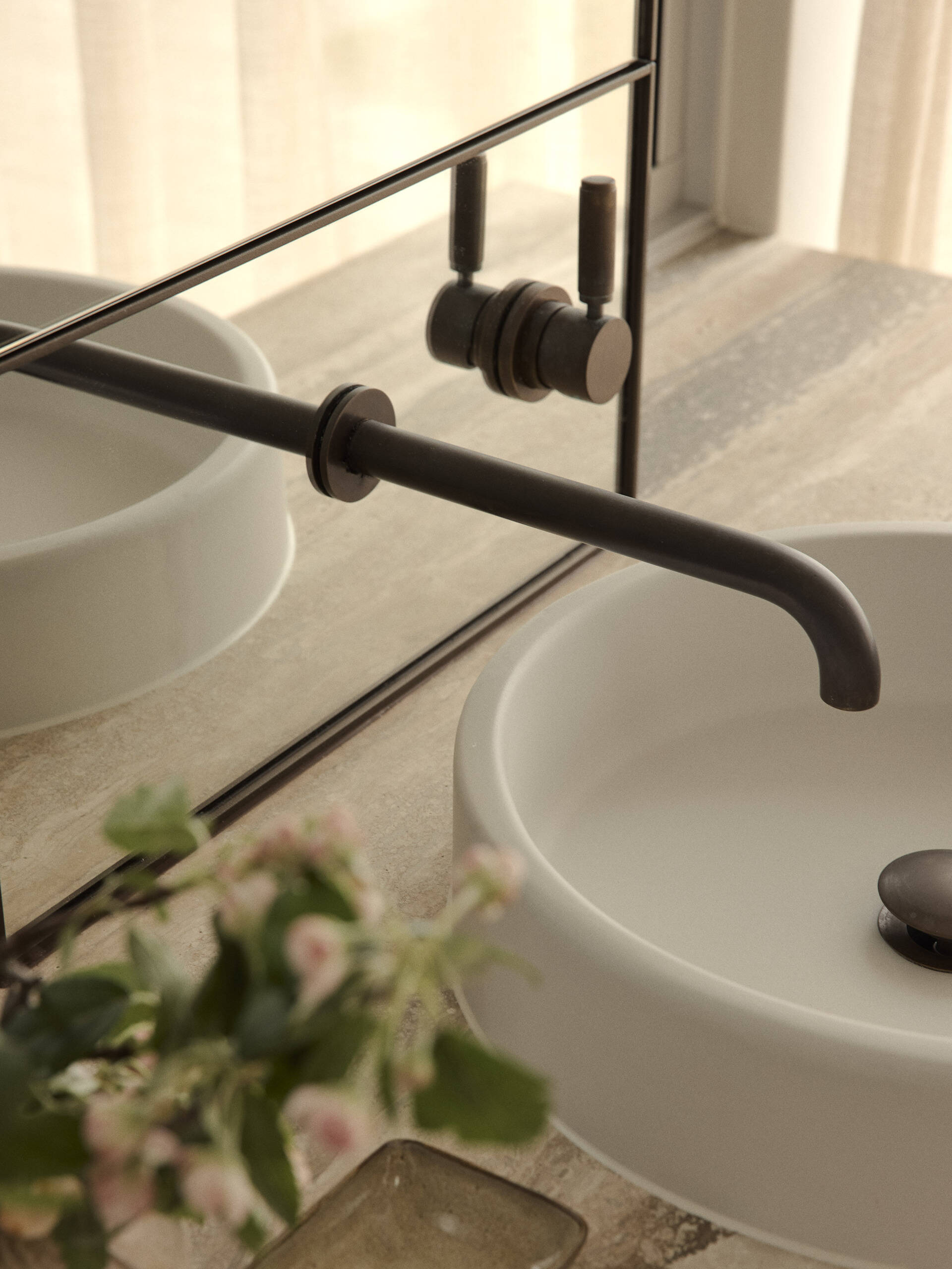 Inside this luxurious Byron Bay ensuite, an organically shaped Agape bath, curved shower and expansive glazing create a beautiful space overlooking the surrounding coastal landscape.