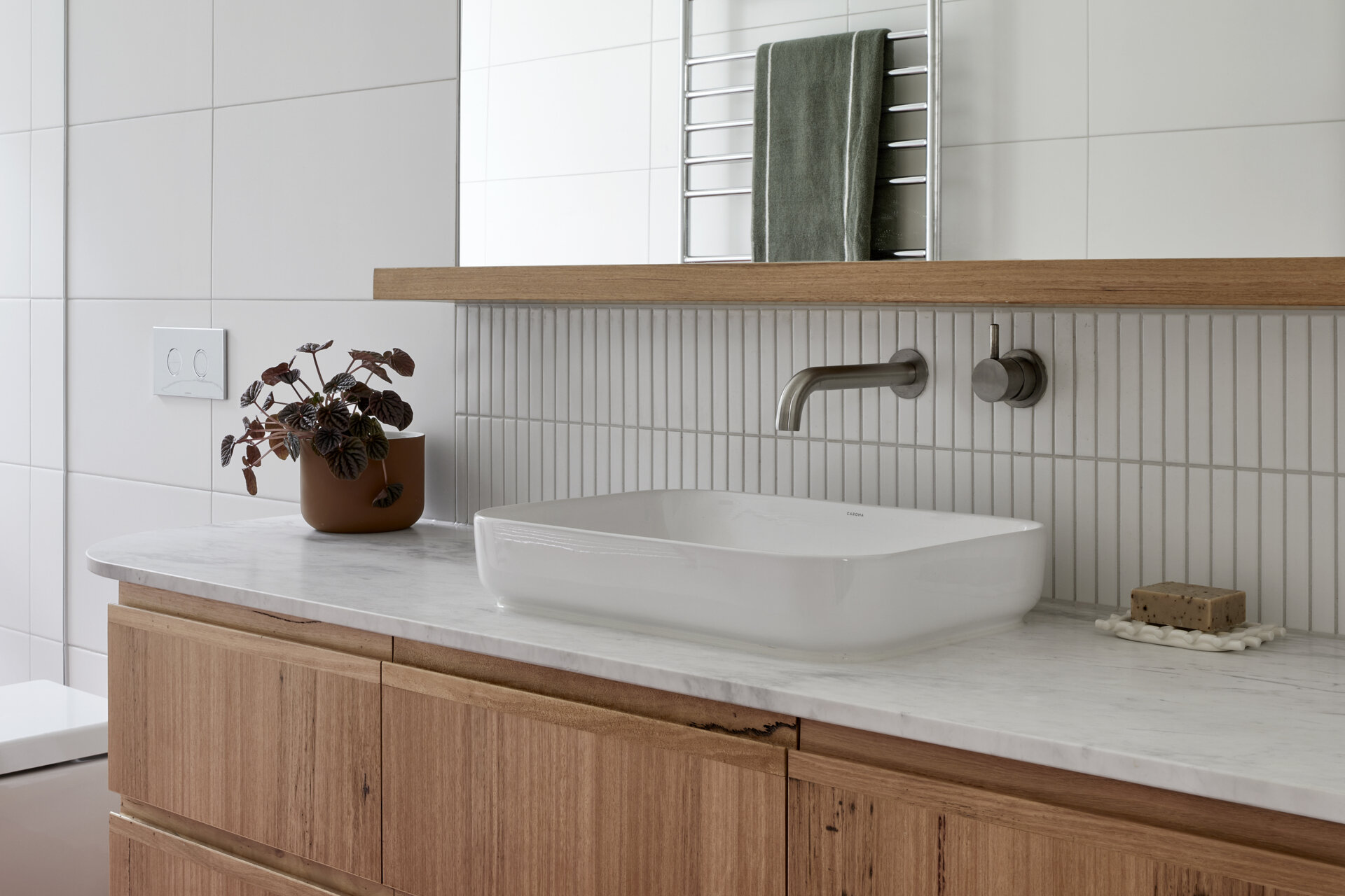 A modern white and wood bathroom.