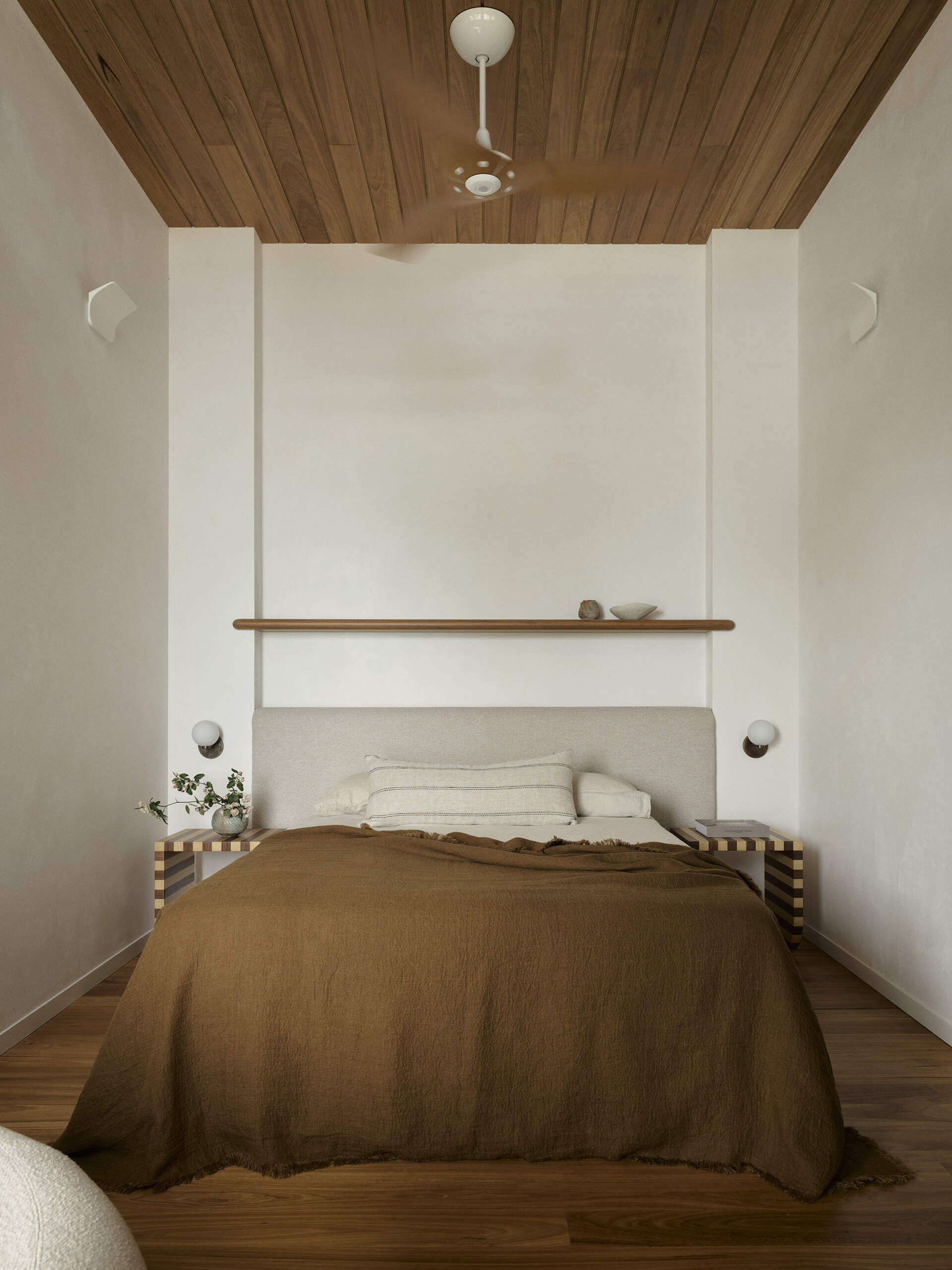 Discover the second guest bedroom in this five-level Byron Bay home, where warm timber, natural finishes and a relaxed palette create a comfortable space for family and guests.