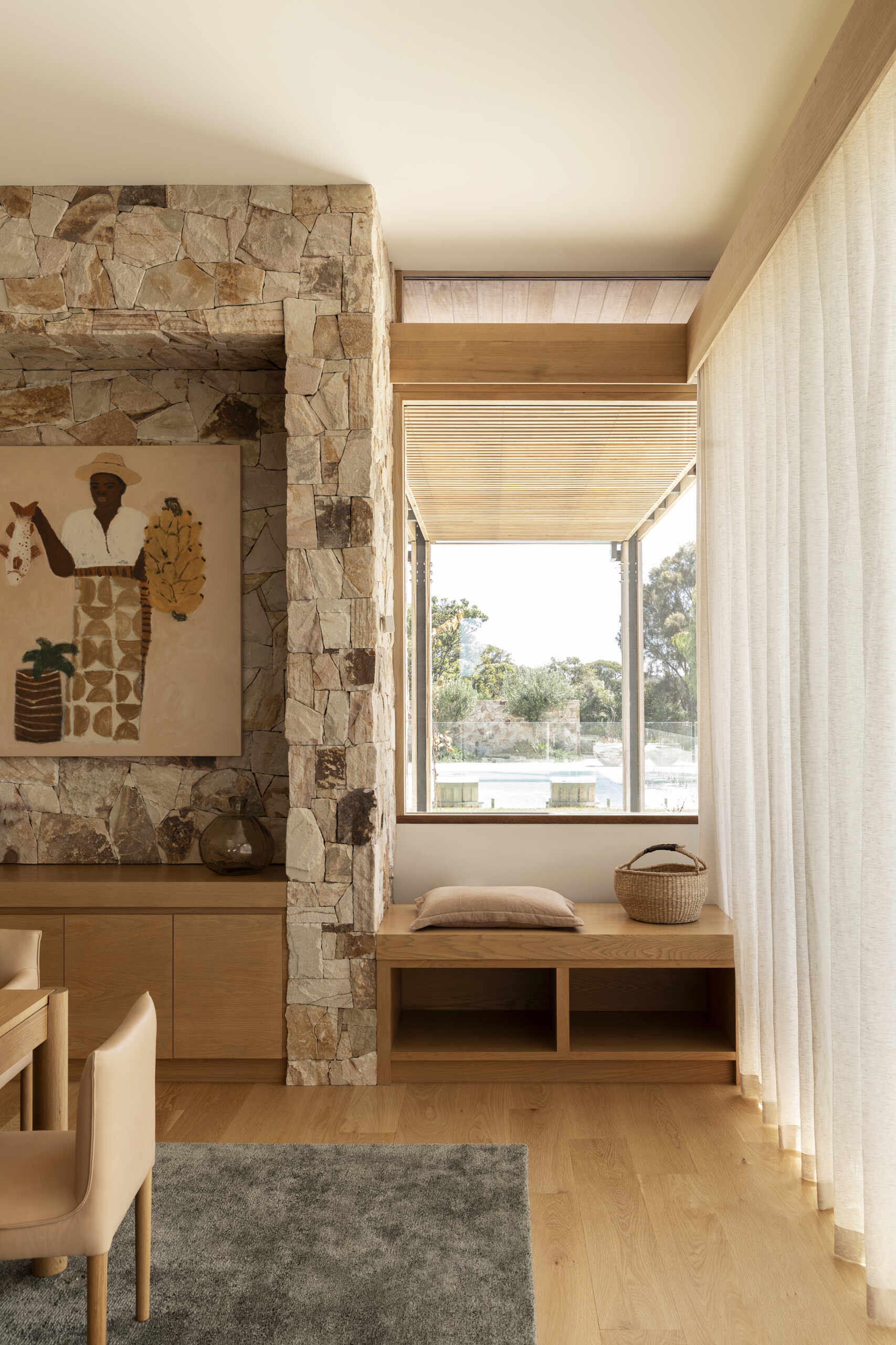 The bench underneath the window adds another place for someone to relax within this open arrangement.