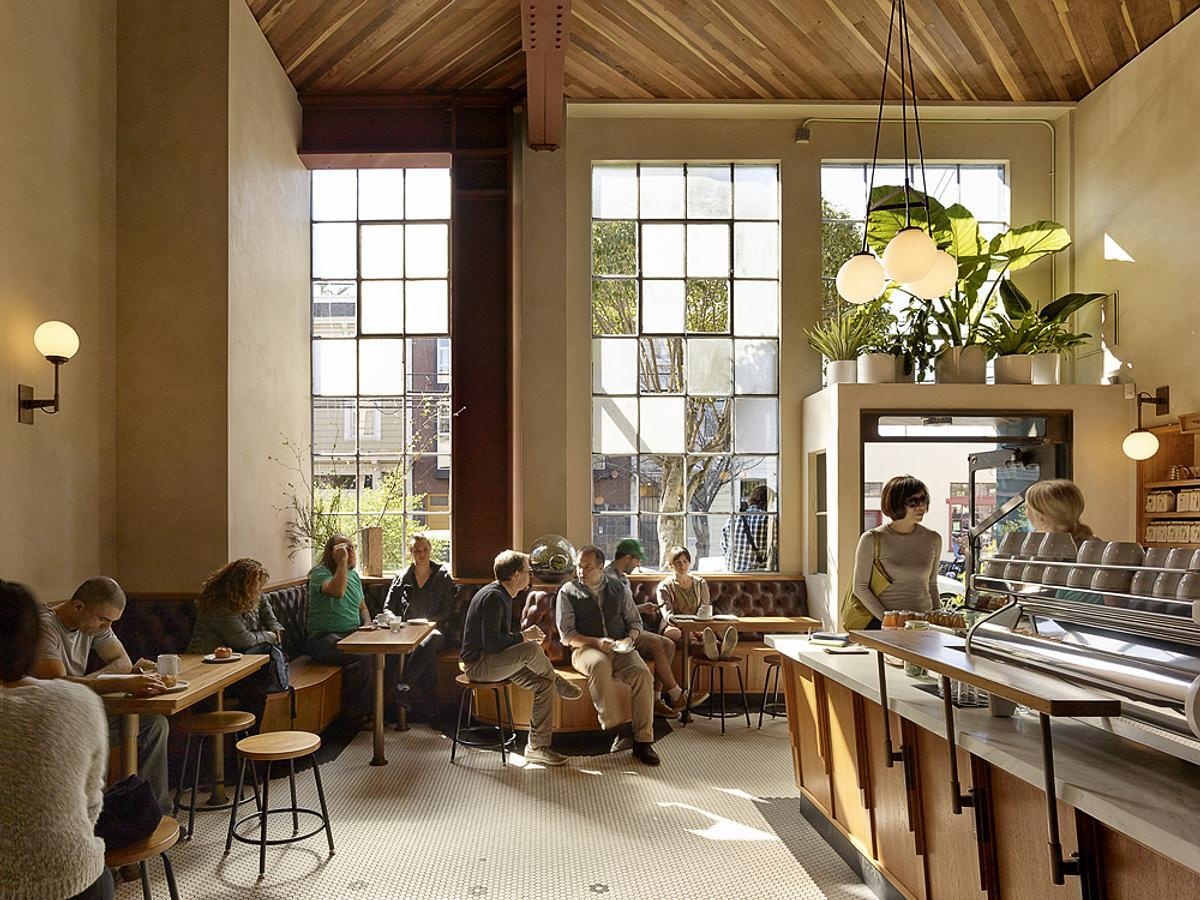 Discover the custom banquette that wraps around the café, offering places for solo coffee breaks, conversations, and larger gatherings.