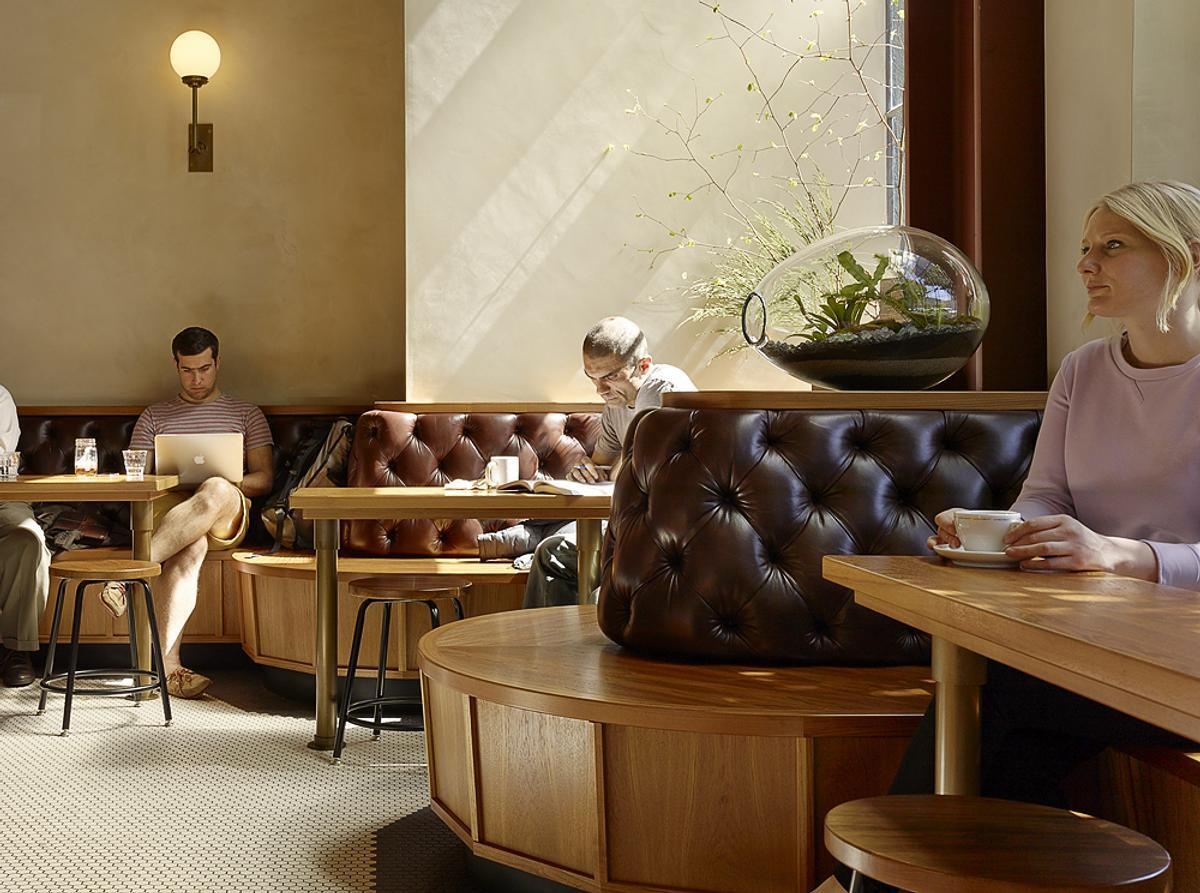 Discover the custom banquette that wraps around the café, offering places for solo coffee breaks, conversations, and larger gatherings.