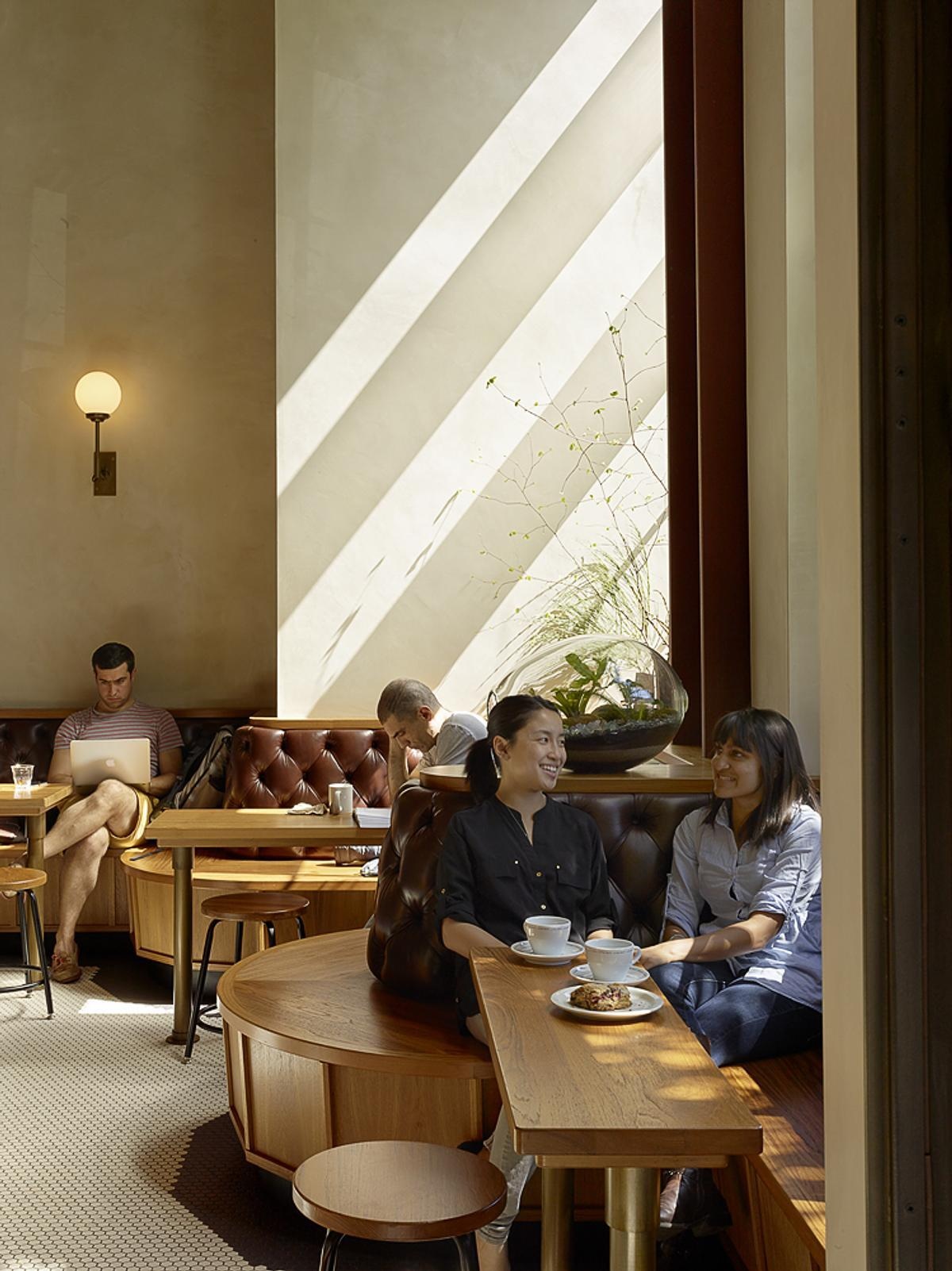 Discover the custom banquette that wraps around the café, offering places for solo coffee breaks, conversations, and larger gatherings.