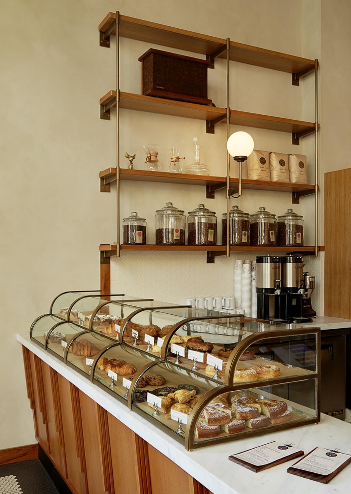 Explore the custom espresso bars, Calacatta Oro stone countertops, and brass pastry display that make the service area a standout feature.