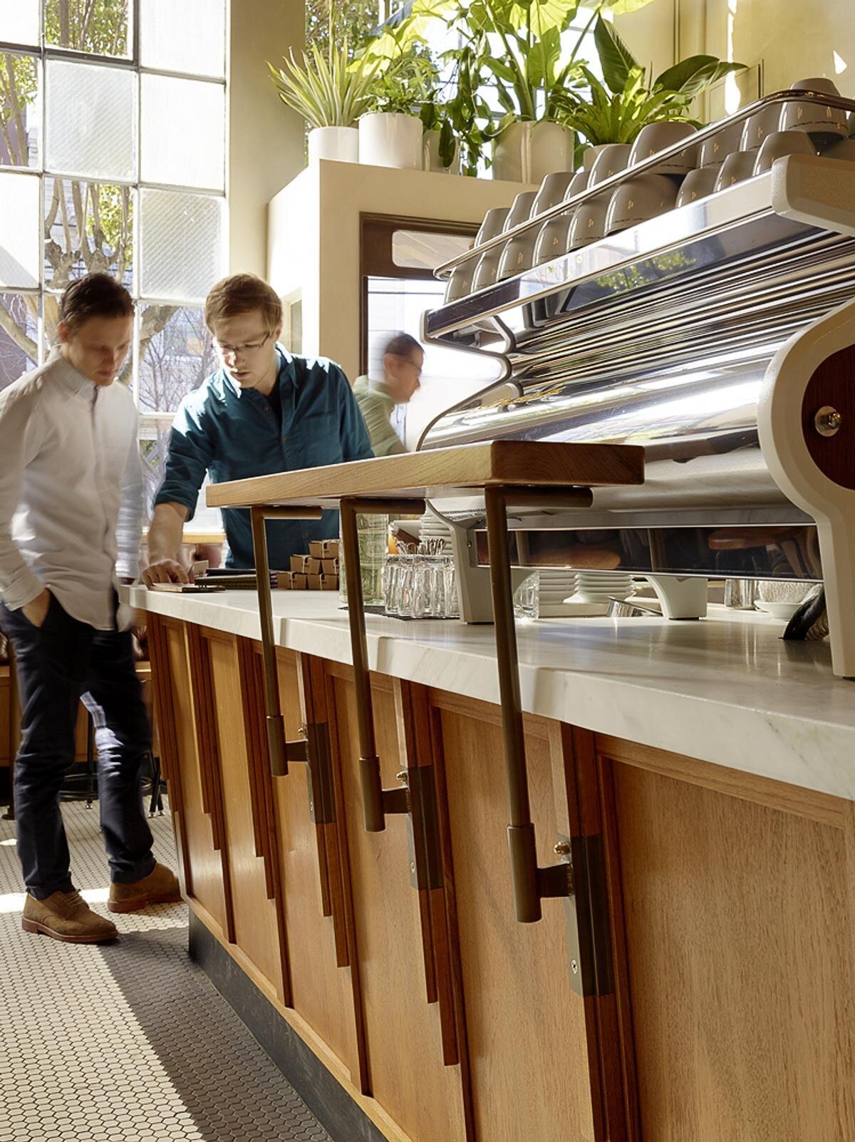 Explore the custom espresso bars, Calacatta Oro stone countertops, and brass pastry display that make the service area a standout feature.