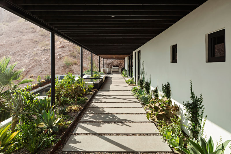 This Phoenix home's covered patio uses misters to stay comfortable in the desert heat and opens toward a hot tub with expansive views of Camelback Mountain and the surrounding desert.