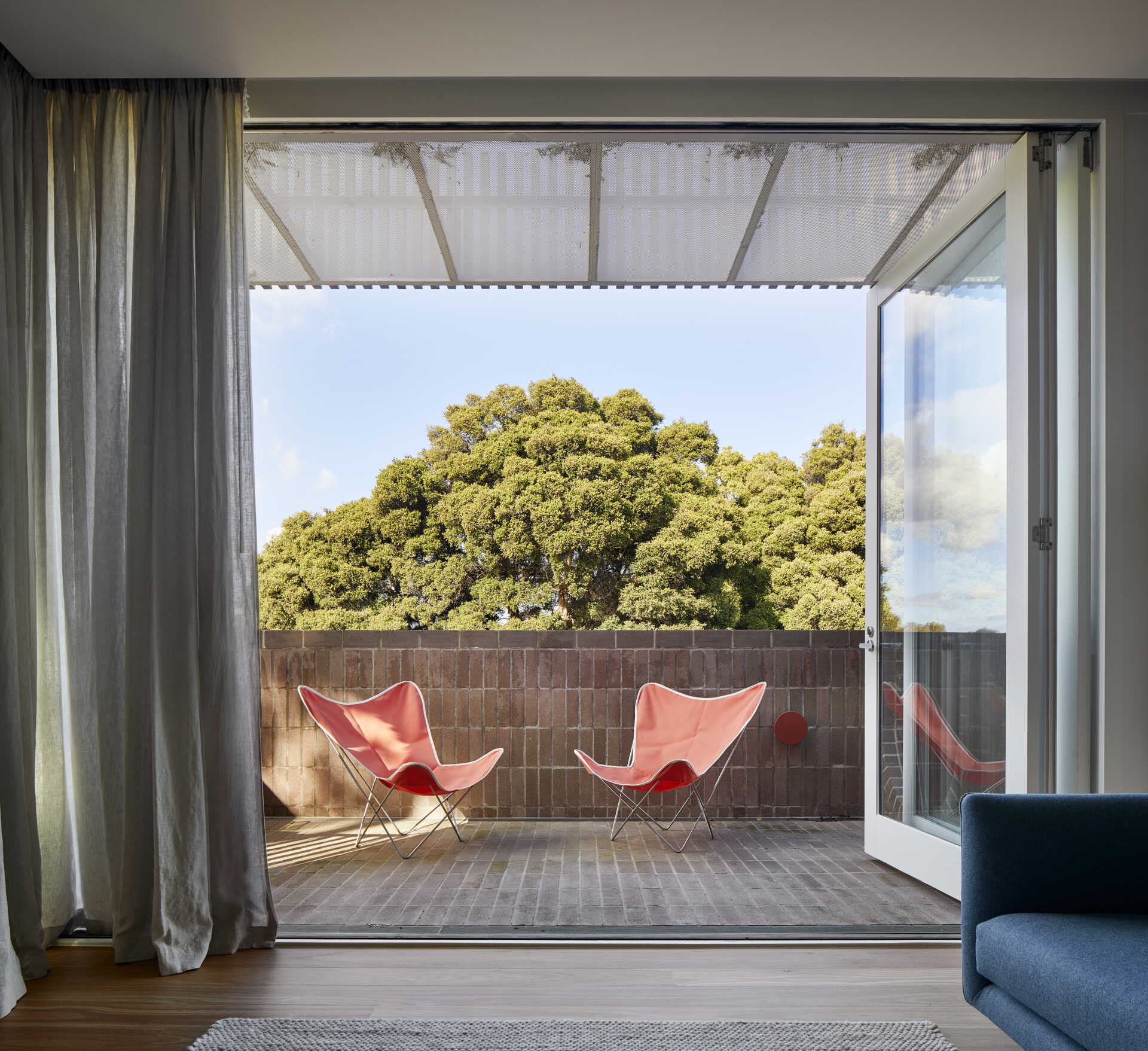 An upstairs family lounge opens onto a balcony overlooking Quarries Park, providing a second shared space for movie nights and family time.
