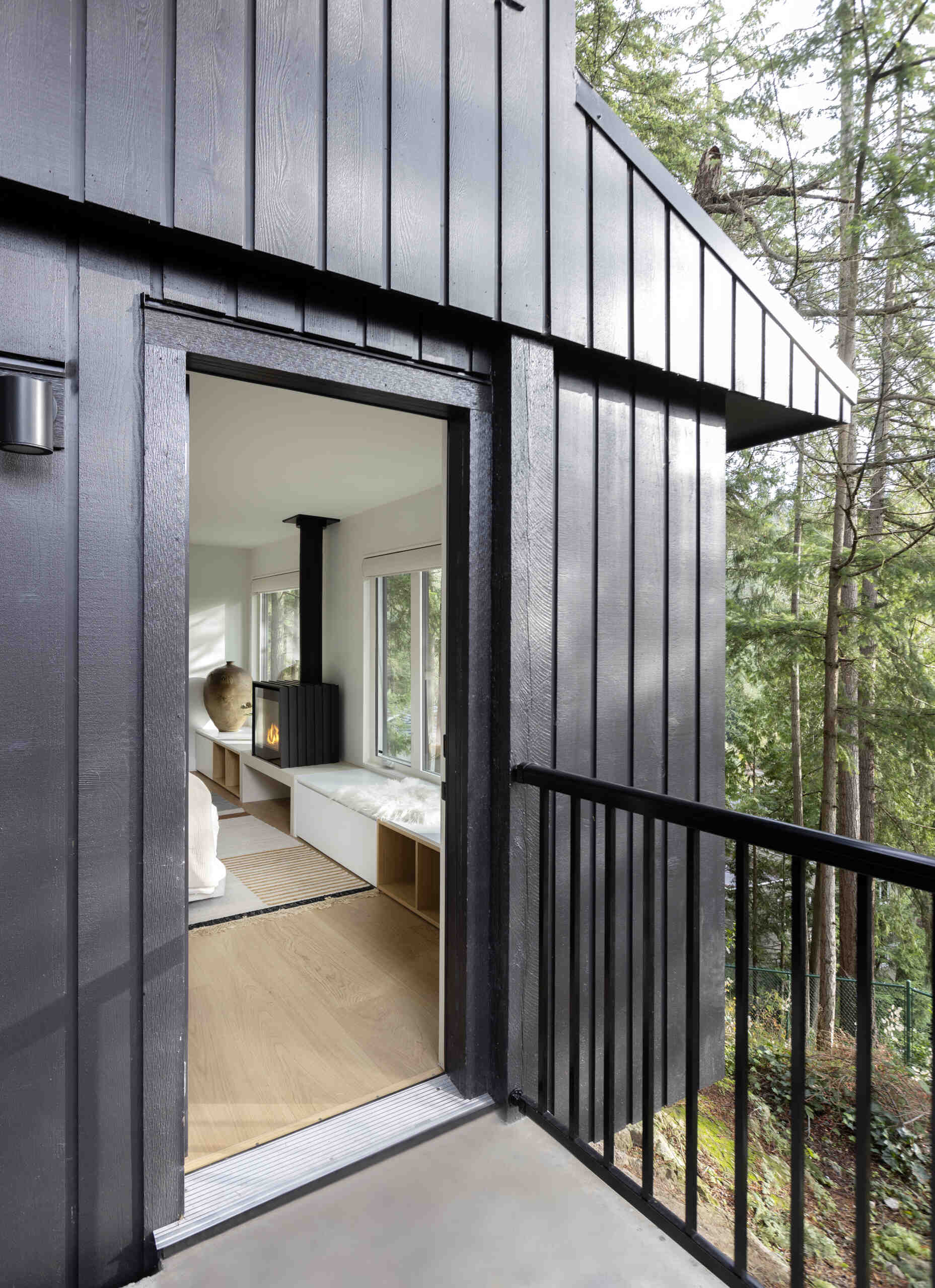 Explore the private guest suite at Westport Place House, complete with a new bathroom, forest views, earthy finishes and a wood-burning fireplace for extra warmth and comfort.