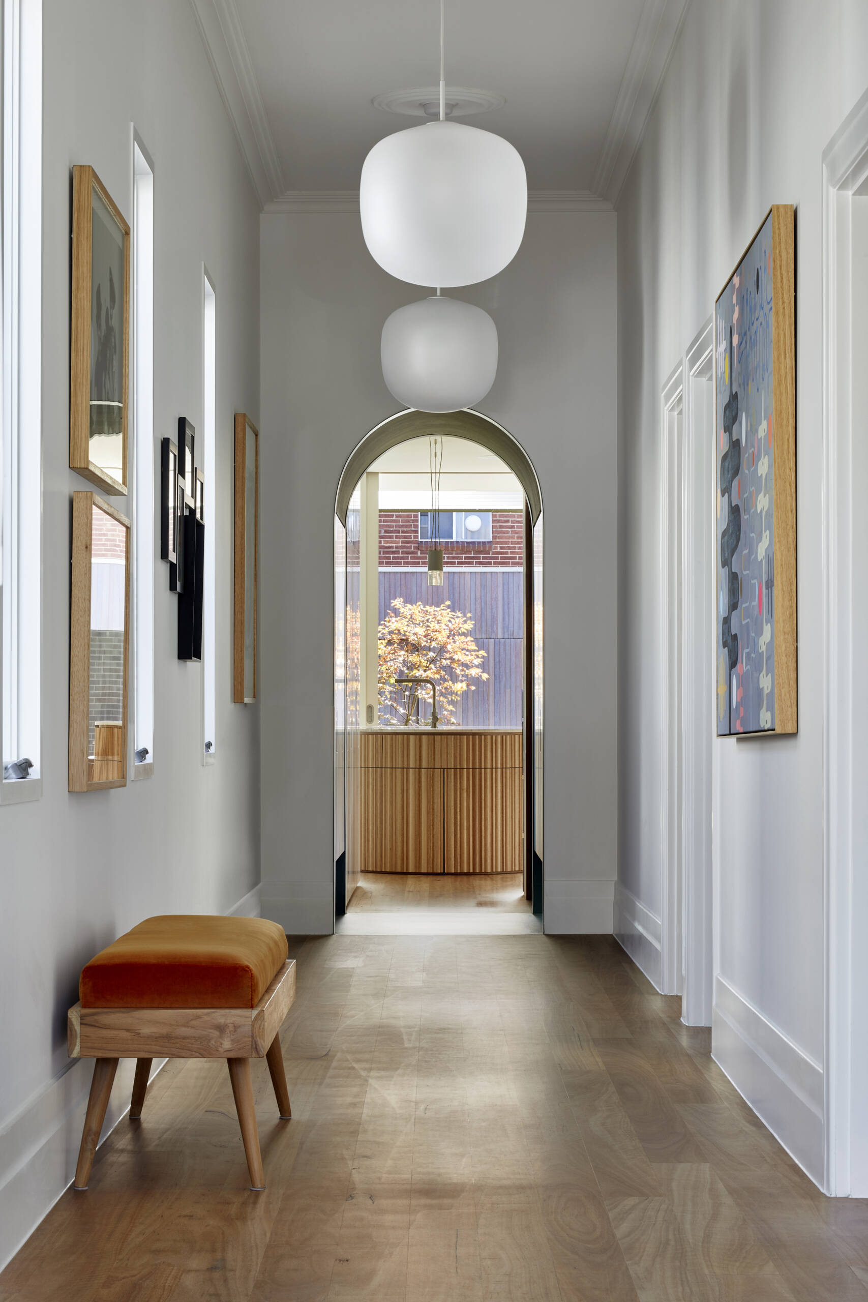A dark green arched passageway called ‘the portal’ links the original Edwardian cottage with the contemporary extension, with built-in storage tucked into the walls.