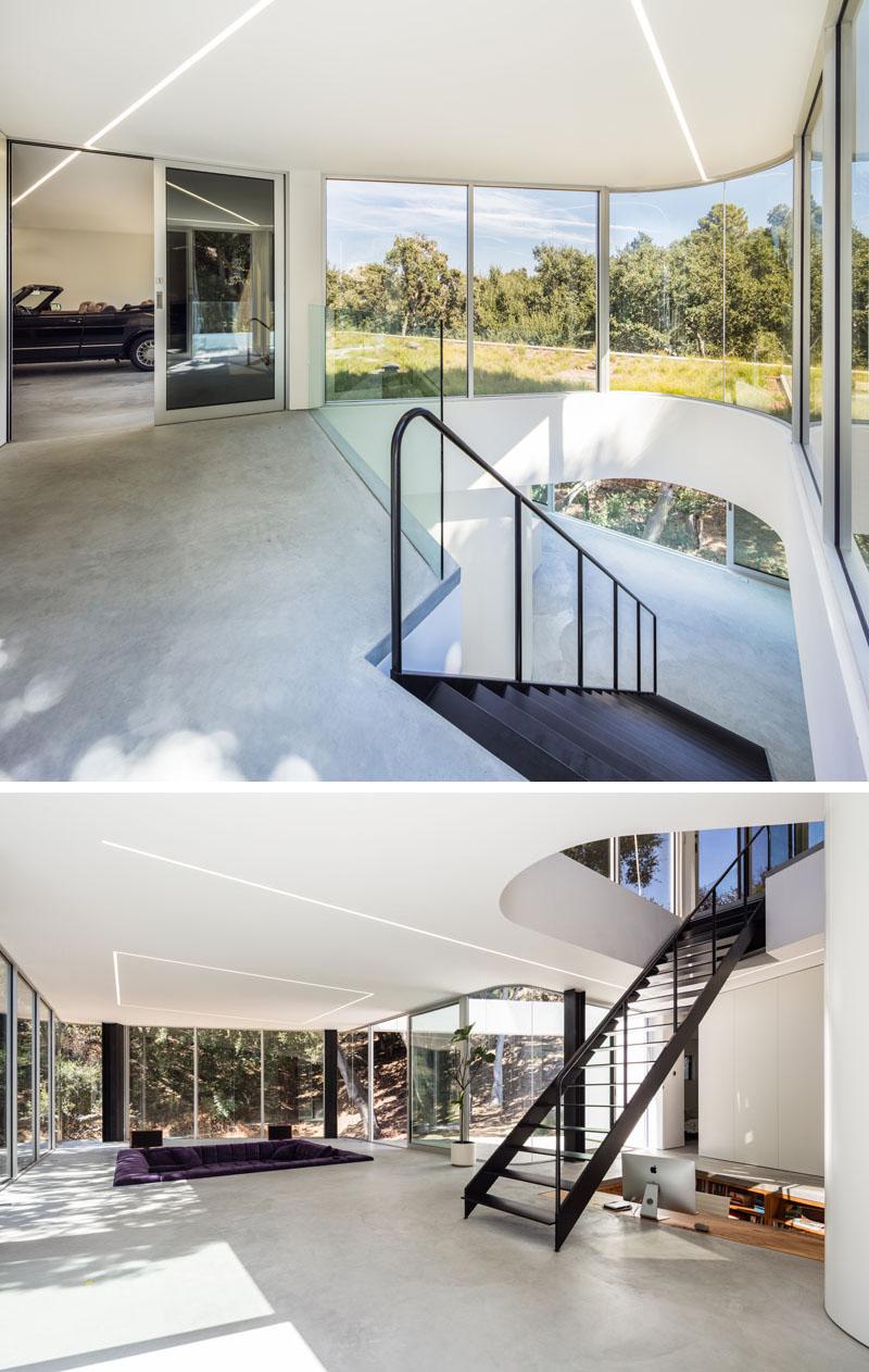 Inside this modern California house, stairs descend from the rooftop entry into a cantilevered living level, with bedrooms, bathrooms and storage tucked behind a long wall of cabinetry.