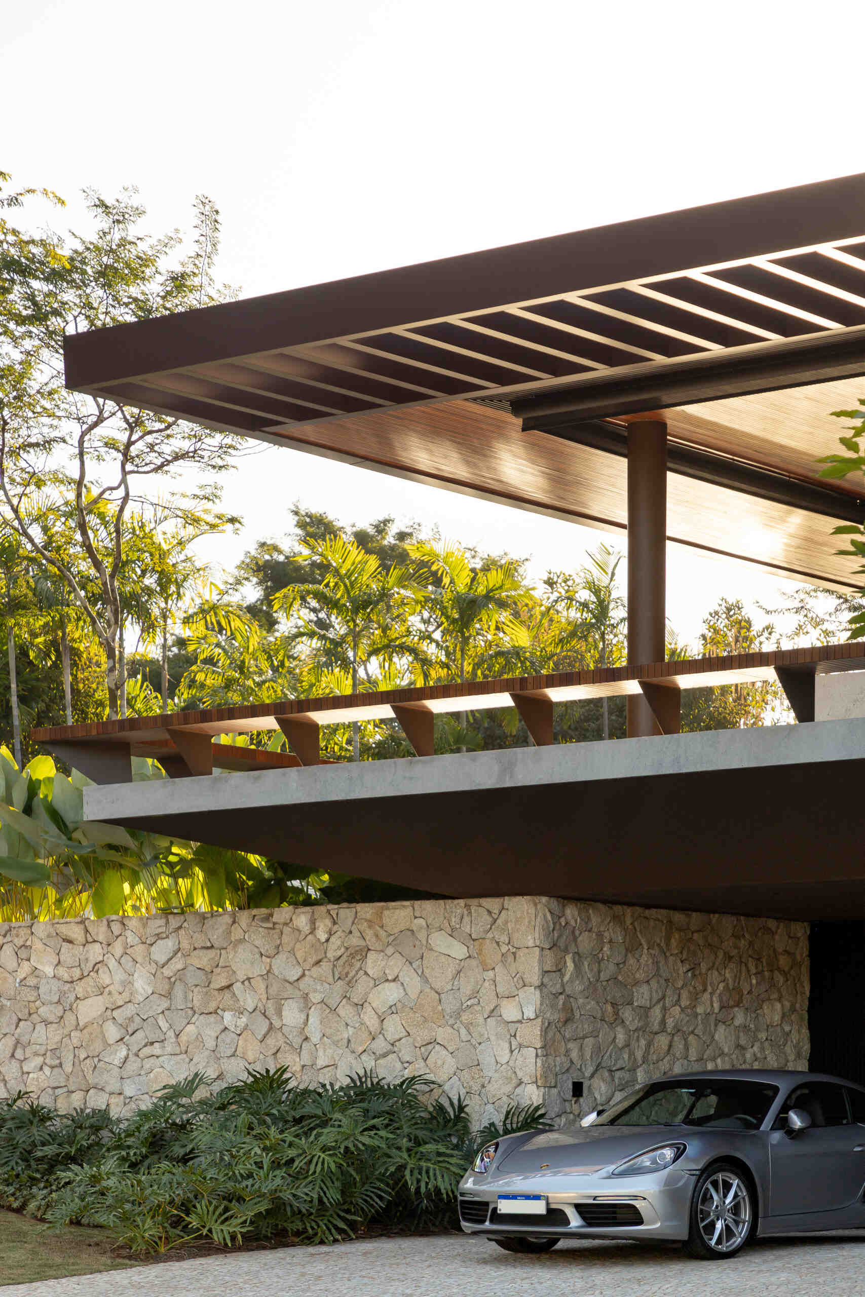 Casa da Mata in Franca, São Paulo, by Lucas Gonçalves Architecture combines minimalist volumes with exposed concrete, warm wood, marble, natural stone and expansive glazing, creating a modern home surrounded by native woodland.