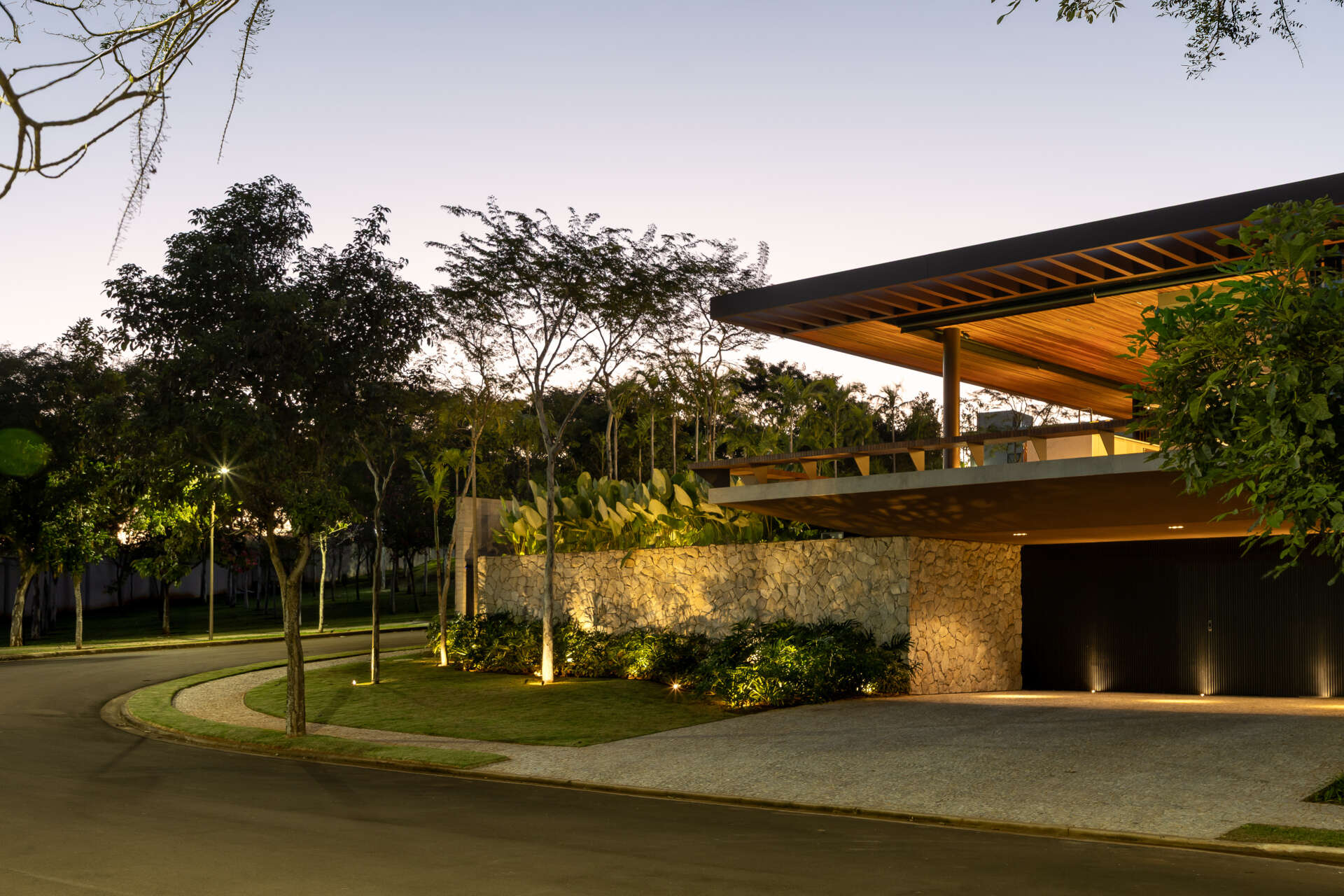 Casa da Mata in Franca, São Paulo, by Lucas Gonçalves Architecture combines minimalist volumes with exposed concrete, warm wood, marble, natural stone and expansive glazing, creating a modern home surrounded by native woodland.