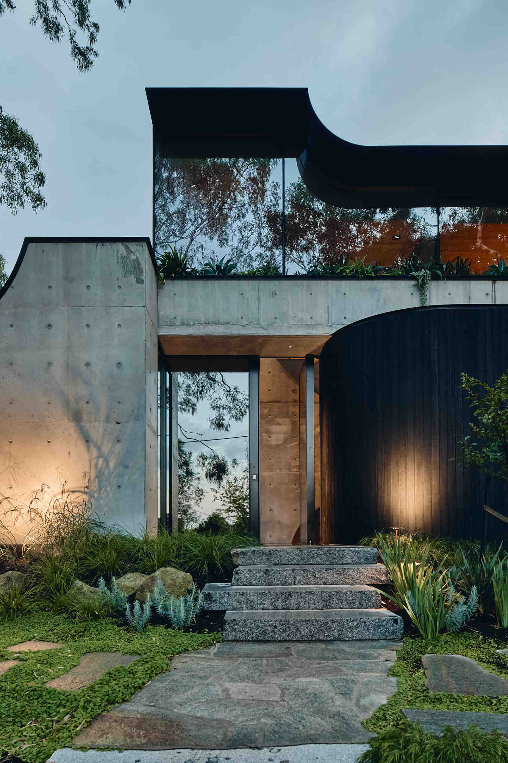 Babylonia by FMD Architects brings curved rooflines, in-situ concrete walls, Tasmanian oak and lush terraces together in a Melbourne home inspired by the Hanging Gardens of Babylon.