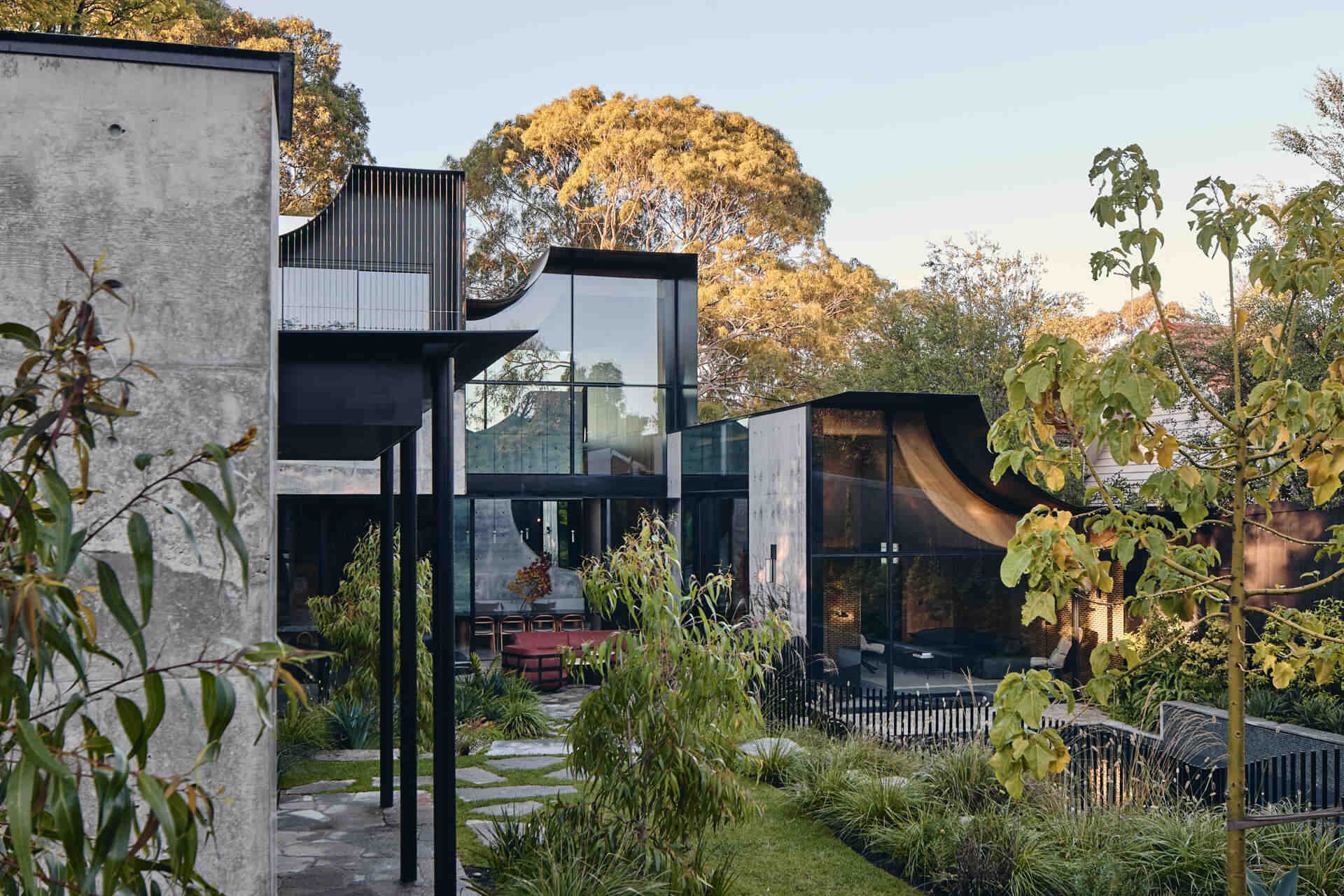 Babylonia by FMD Architects brings curved rooflines, in-situ concrete walls, Tasmanian oak and lush terraces together in a Melbourne home inspired by the Hanging Gardens of Babylon.