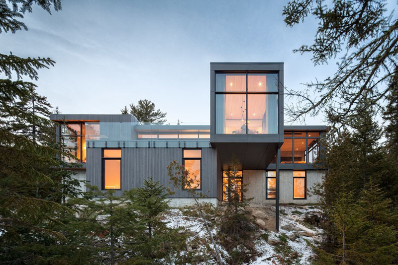 Long Horizontals by Thellend Fortin Architectes is a modern Québec house built on a steep rocky site overlooking the St. Lawrence River, with long horizontal forms, concrete, light wood and expansive glass opening the home toward the horizon.