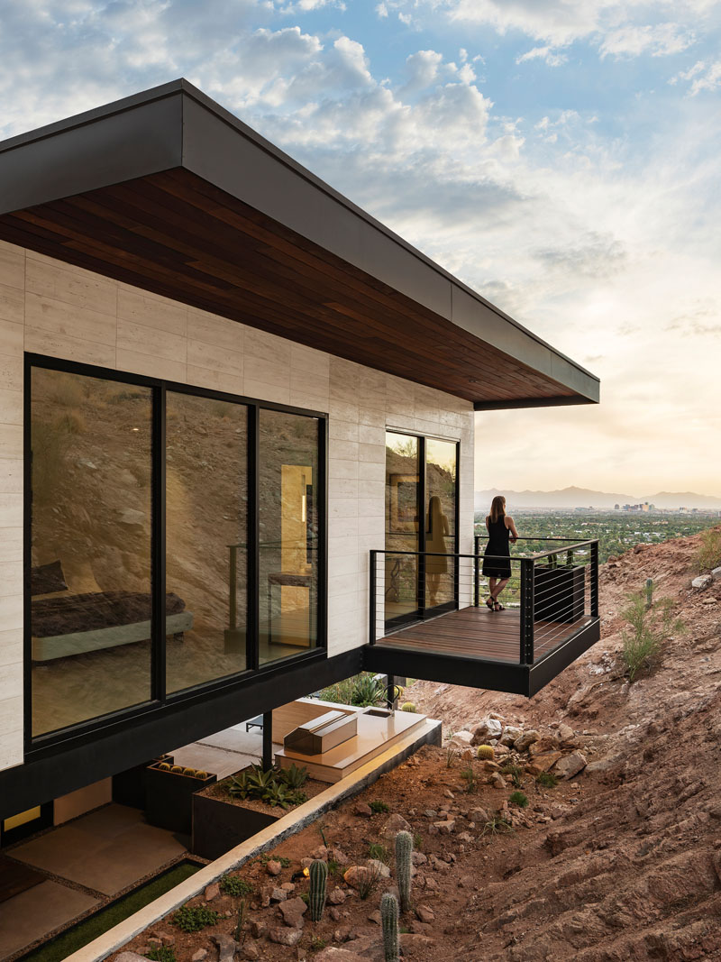 A cantilevered Juliet balcony extends from the second floor of this Camelback Mountain home, bringing the upper-level architecture close to the mountain face and opening the house to expansive Arizona views.