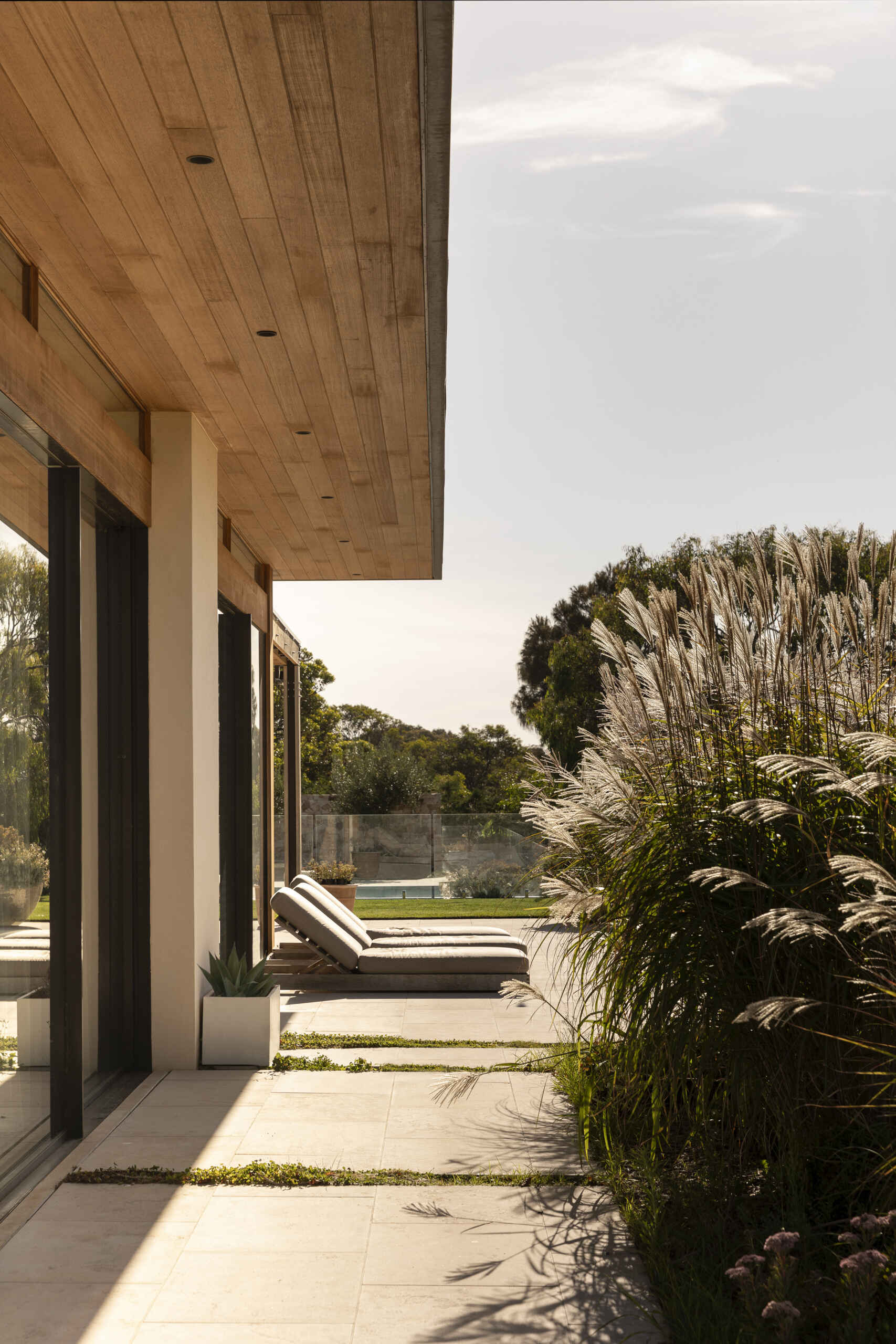 Discover the outdoor spaces at Smoke Bush House, where sheltered pavilions, a pool, patio, deck and outdoor shower extend the home into its surrounding landscape.