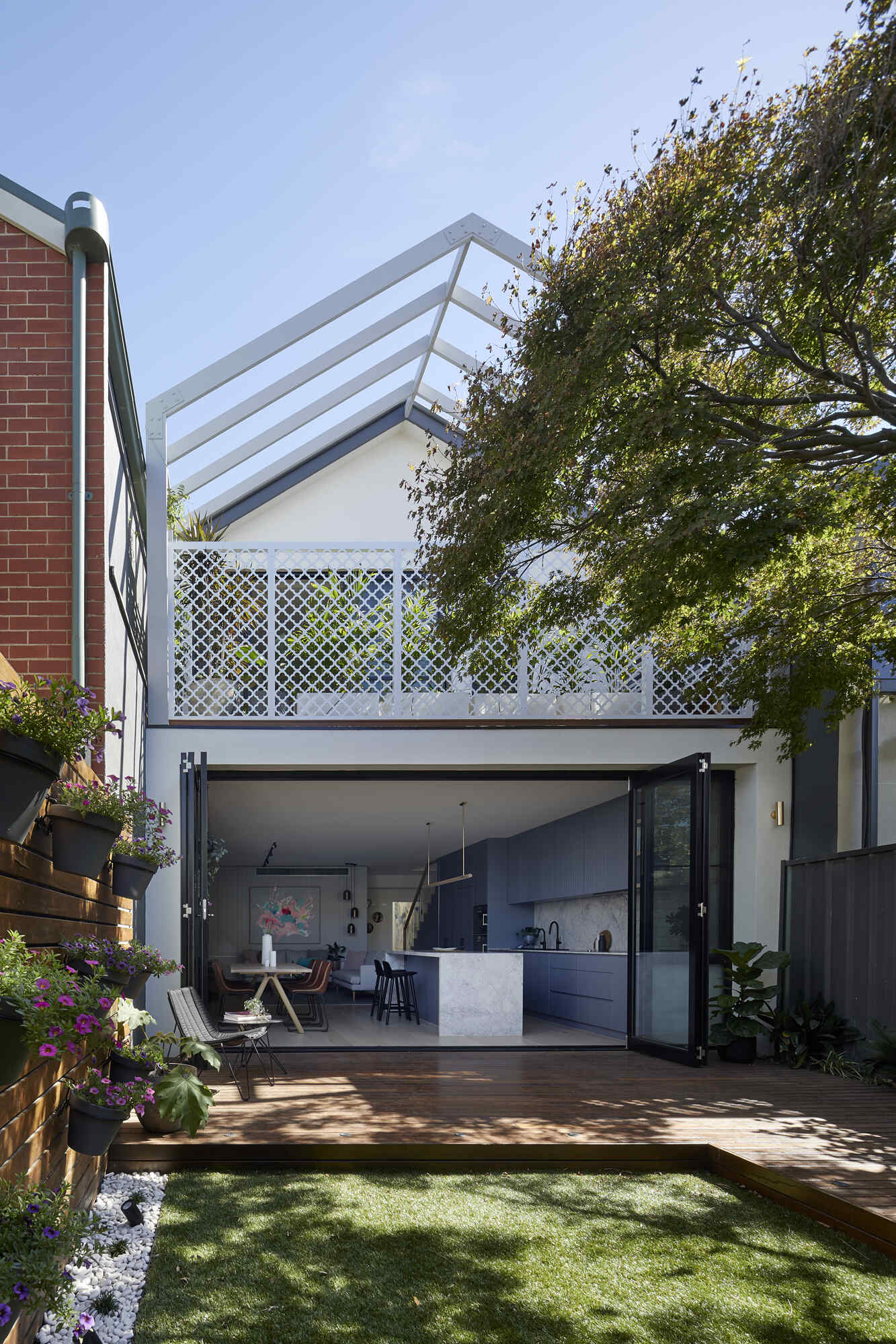 A reworked gable pergola and clover-patterned balcony give this Port Melbourne renovation a fresh architectural detail inspired by the original cottage.