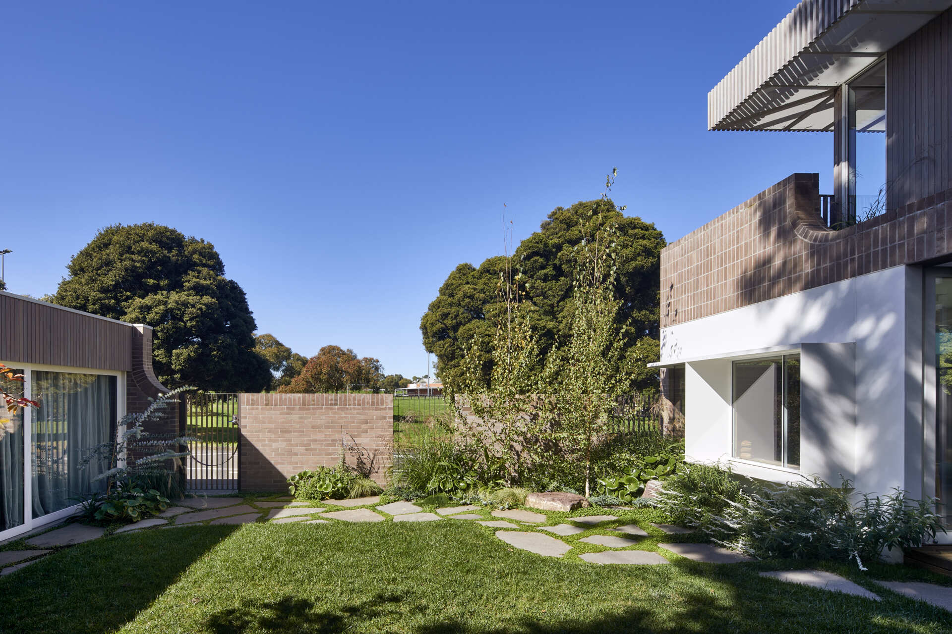 A compact Clifton Hill garden becomes an outdoor room with steppingstones, hidden water jets and a detached studio with its own bedroom, bathroom and kitchenette.
