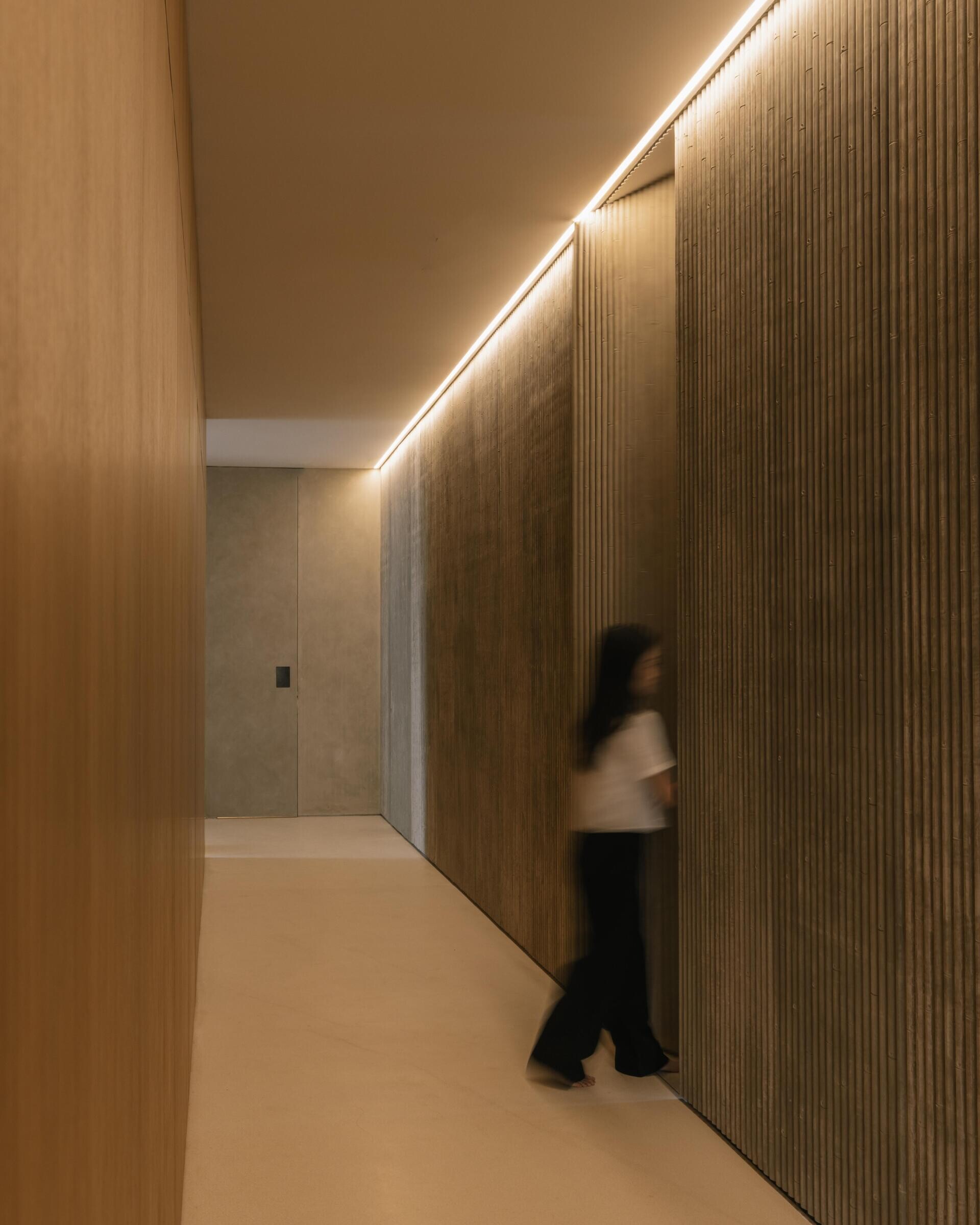 The ground floor of Split Mass Residence combines an office, meeting room, service areas and a garden arcade, creating a separate working zone within the family home.