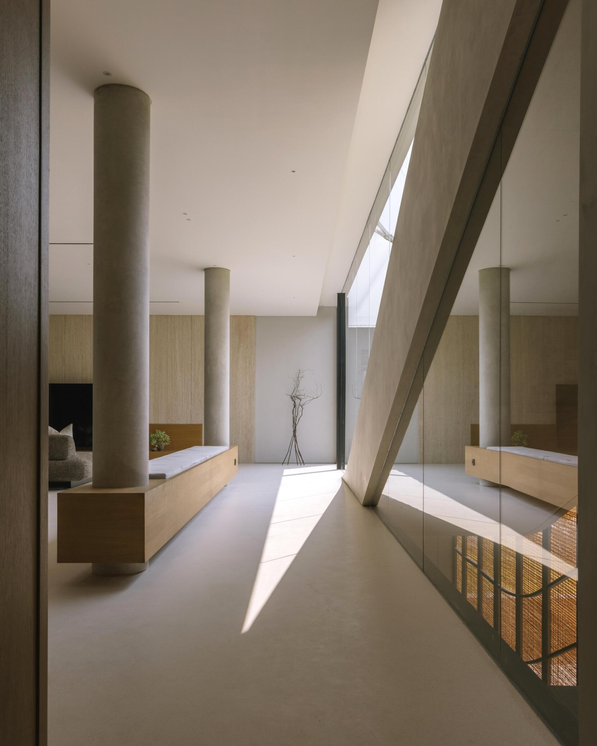 Take a look inside the private first floor of Split Mass Residence, with a living room, dining area, kitchen and entertainment discussion area arranged alongside the family bedrooms.