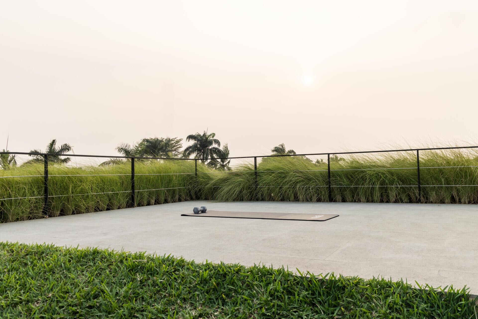 At the highest level of Split Mass Residence, an outdoor yoga area sits above the swimming pool, while a fully planted green roof adds another layer of landscape.