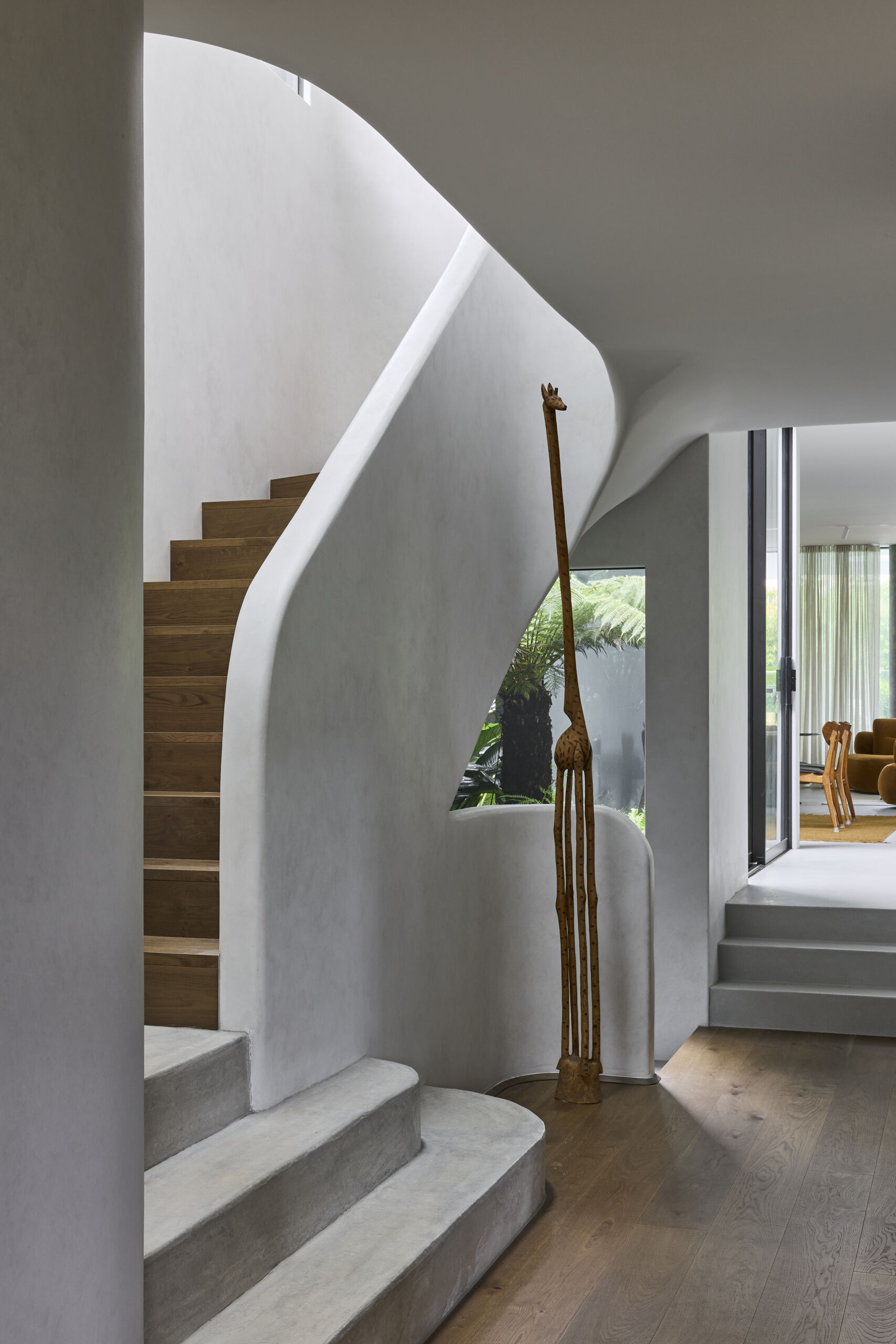 Explore the staircase at Sasso Nero, curved forms and natural light from overhead skylights bring architectural detail to the transition between levels.
