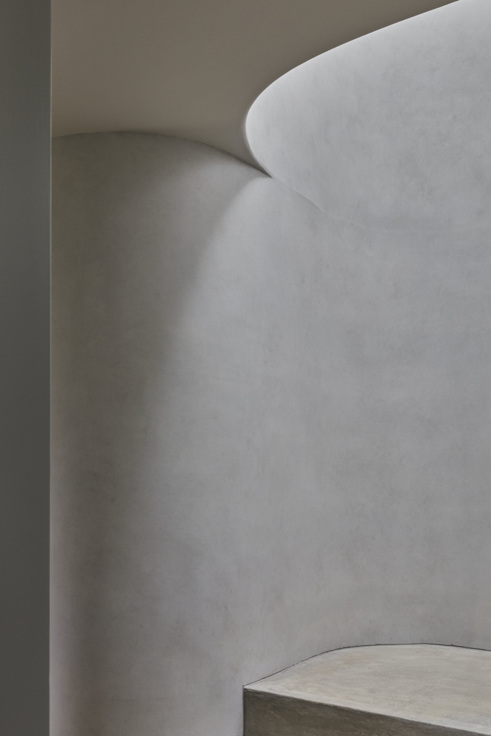 Explore the staircase at Sasso Nero, curved forms and natural light from overhead skylights bring architectural detail to the transition between levels.