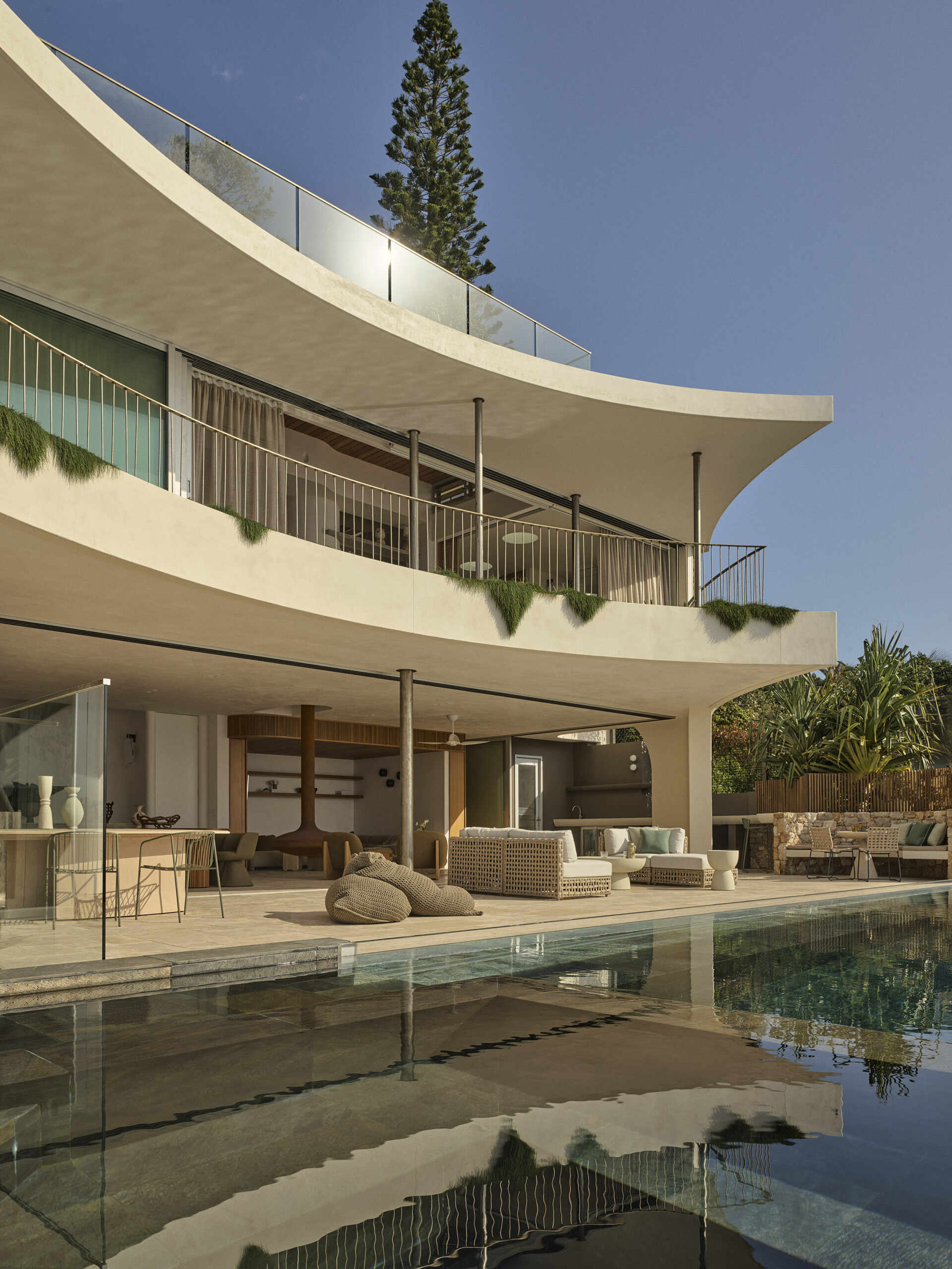 Take a look at the expansive outdoor terrace of this Wategos Beach home, where the main living spaces open directly outdoors and elevated gardens soften the multi-level architecture.