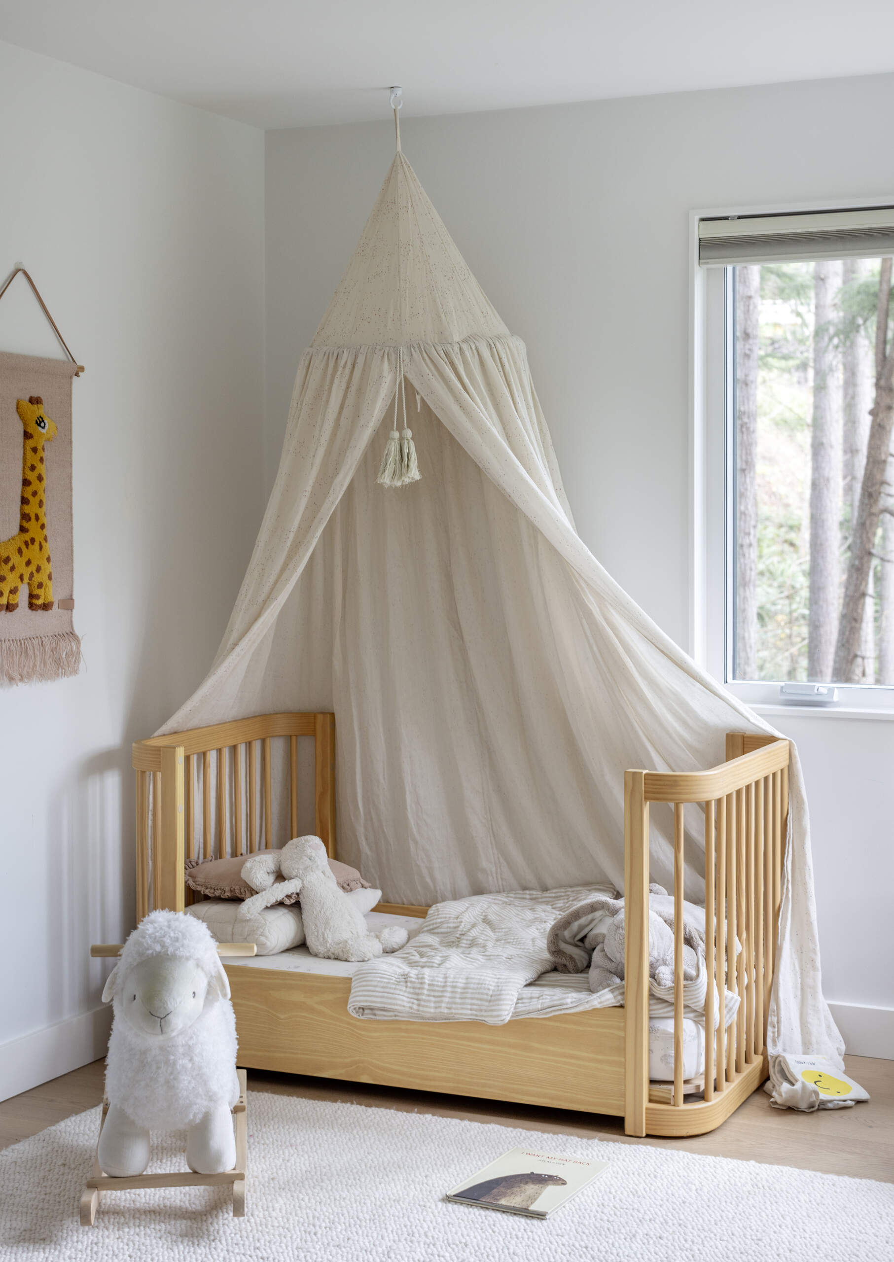 A charming children's bedroom and playful terrazzo bathroom feature in the lower level of this renovated West Vancouver mid-century home, designed for a growing family.