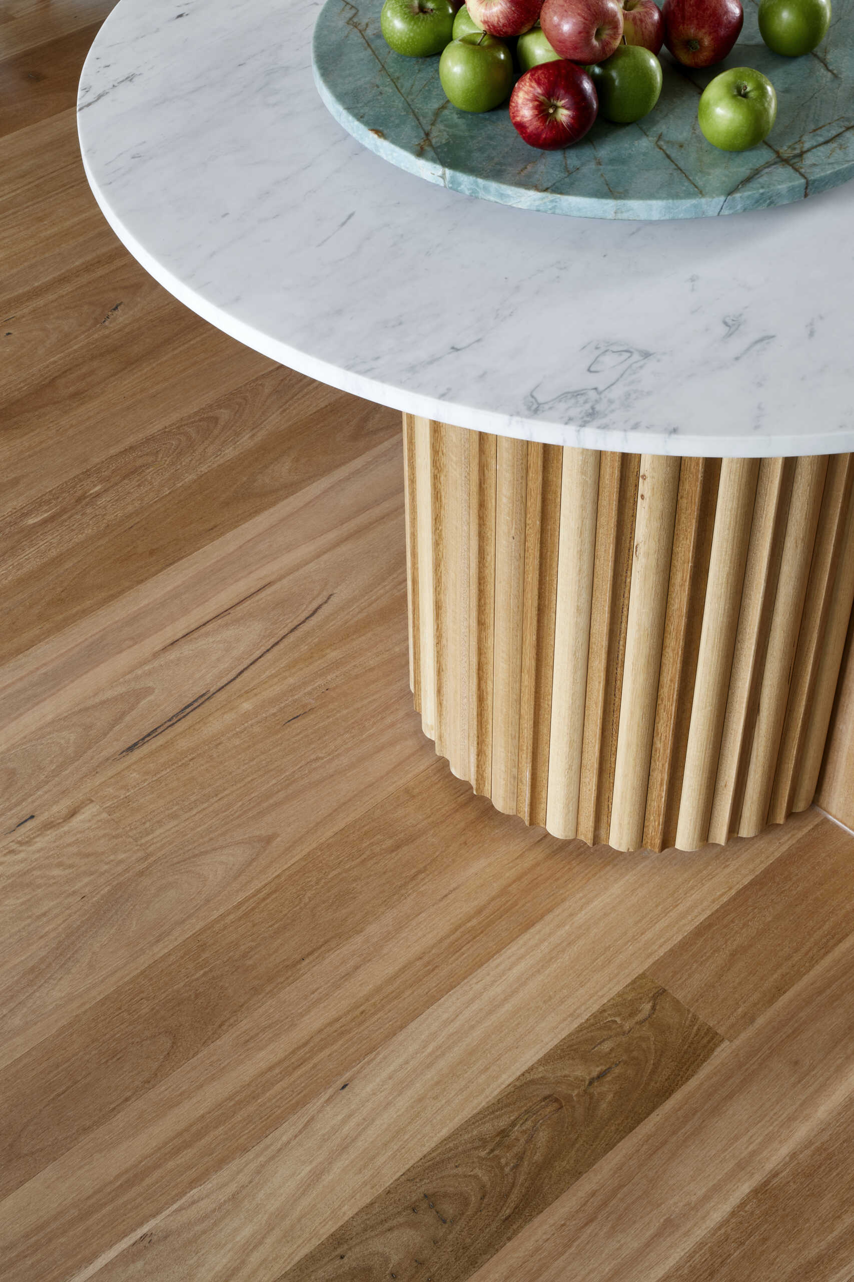 A generous Melbourne kitchen combines Blackbutt timber and white cabinets, with a island that adds texture and curves.