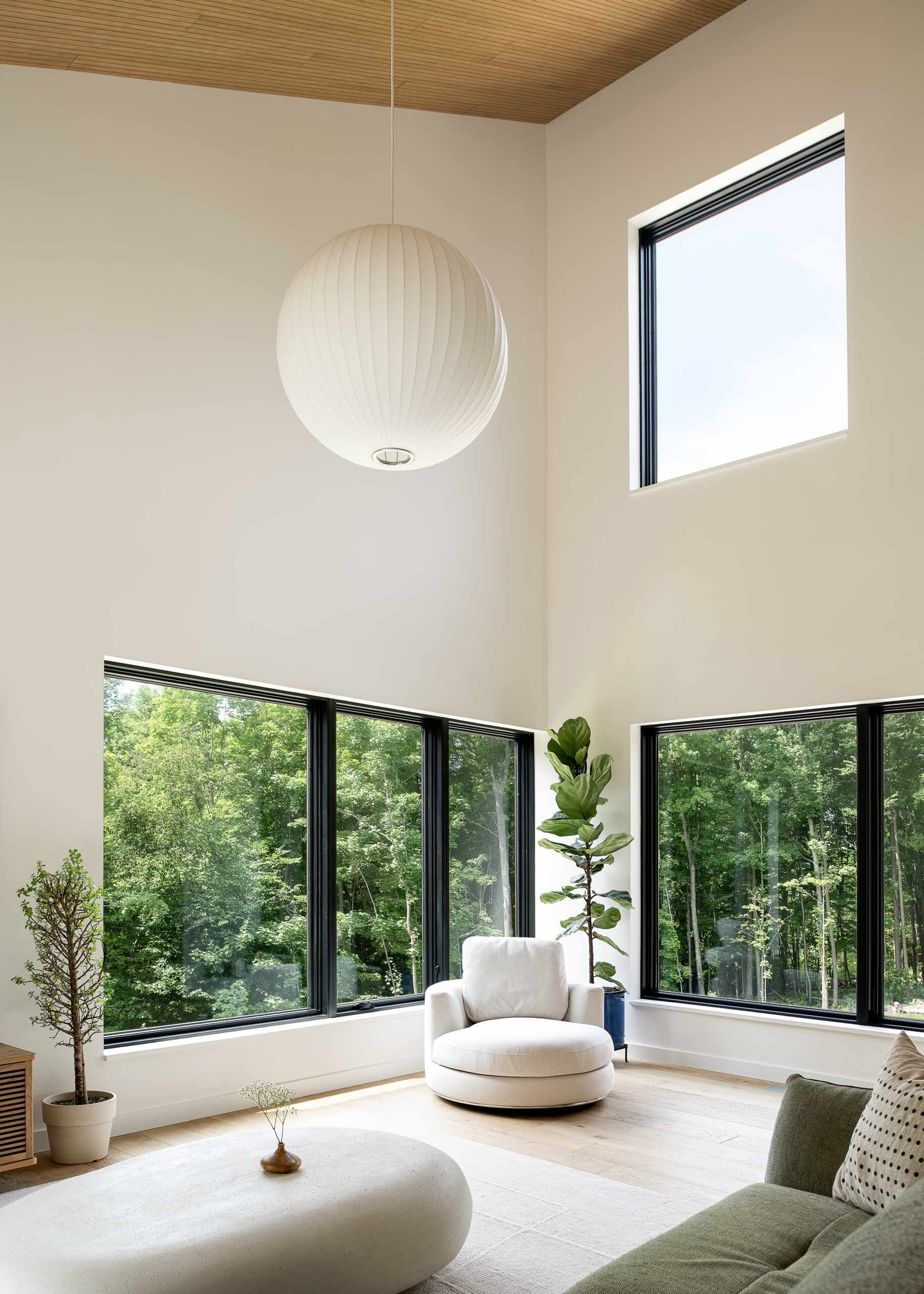 See inside the soaring living room of the Milo House, where cathedral-like ceilings, natural light, pale wood and views toward the Adirondacks create an airy interior.