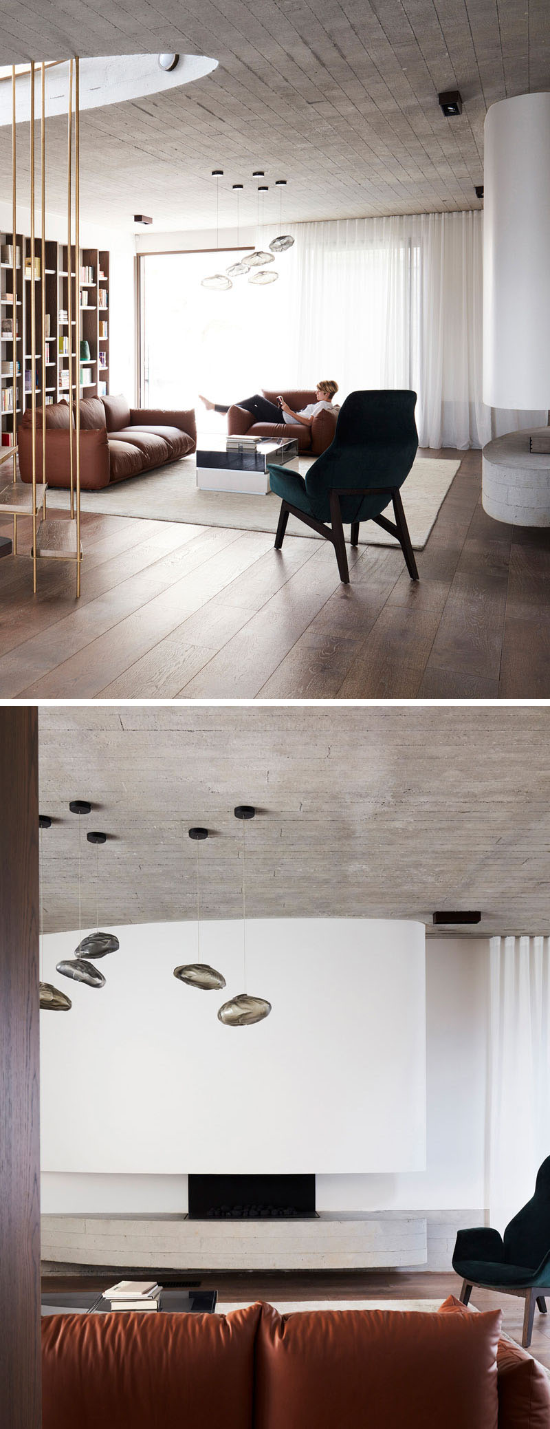 The living room at The Books House pairs board-formed concrete, American Oak flooring, a curved fireplace and timber bookshelves in a warm contemporary interior.