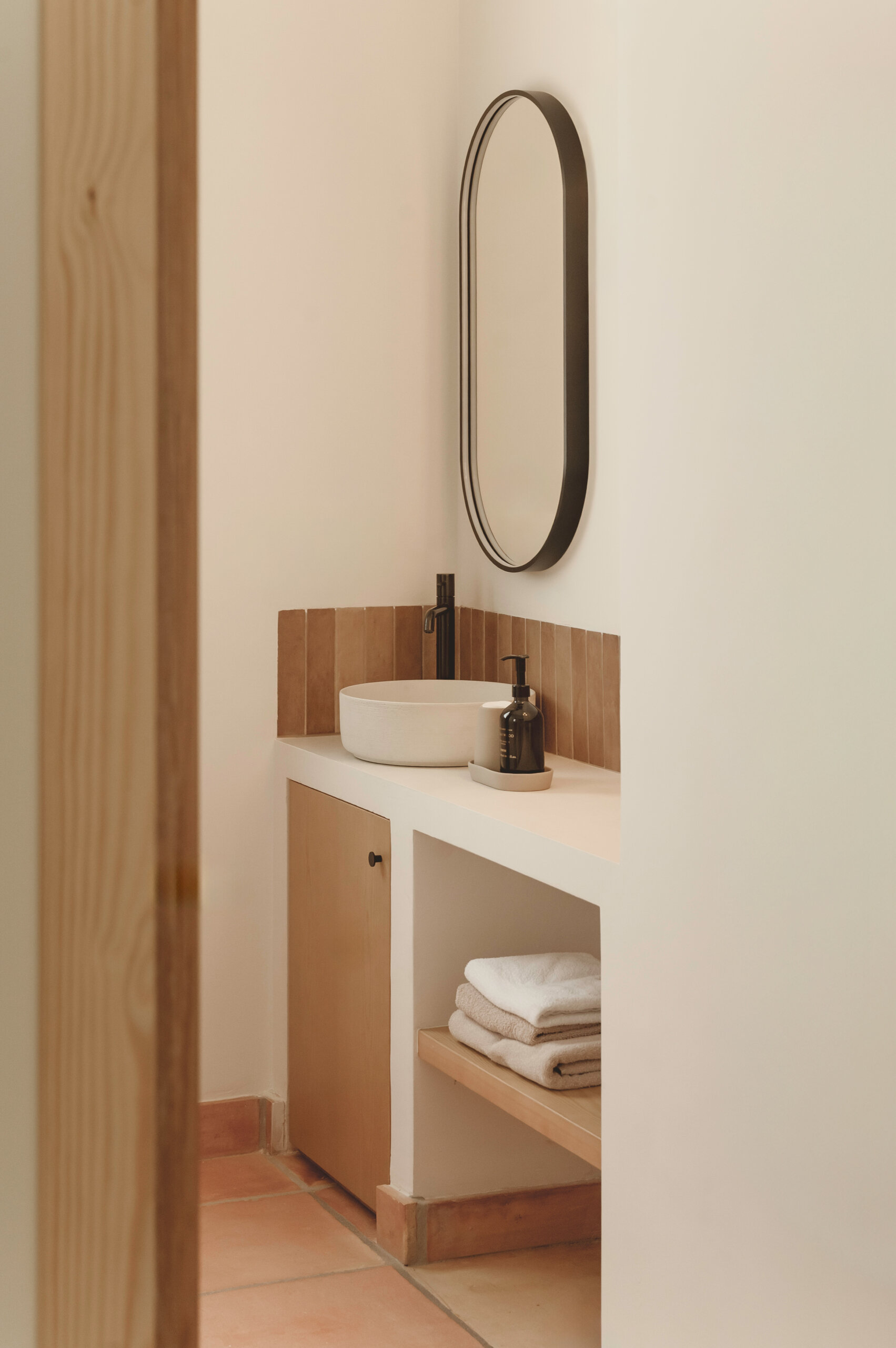 Textured ceramic walls, custom lighting and warm finishes make these Mediterranean bathrooms full of character.