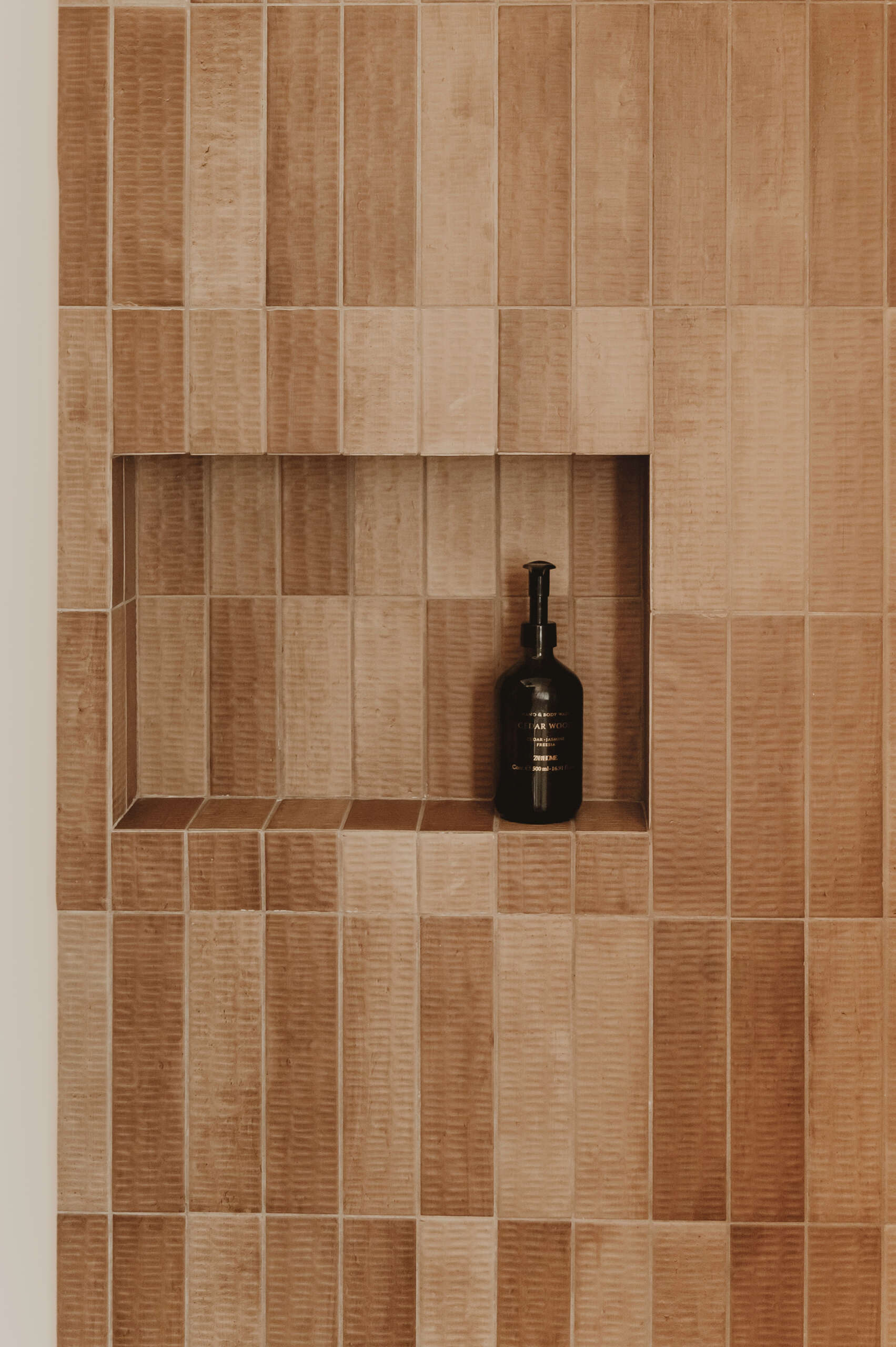 Textured ceramic walls, custom lighting and warm finishes make these Mediterranean bathrooms full of character.