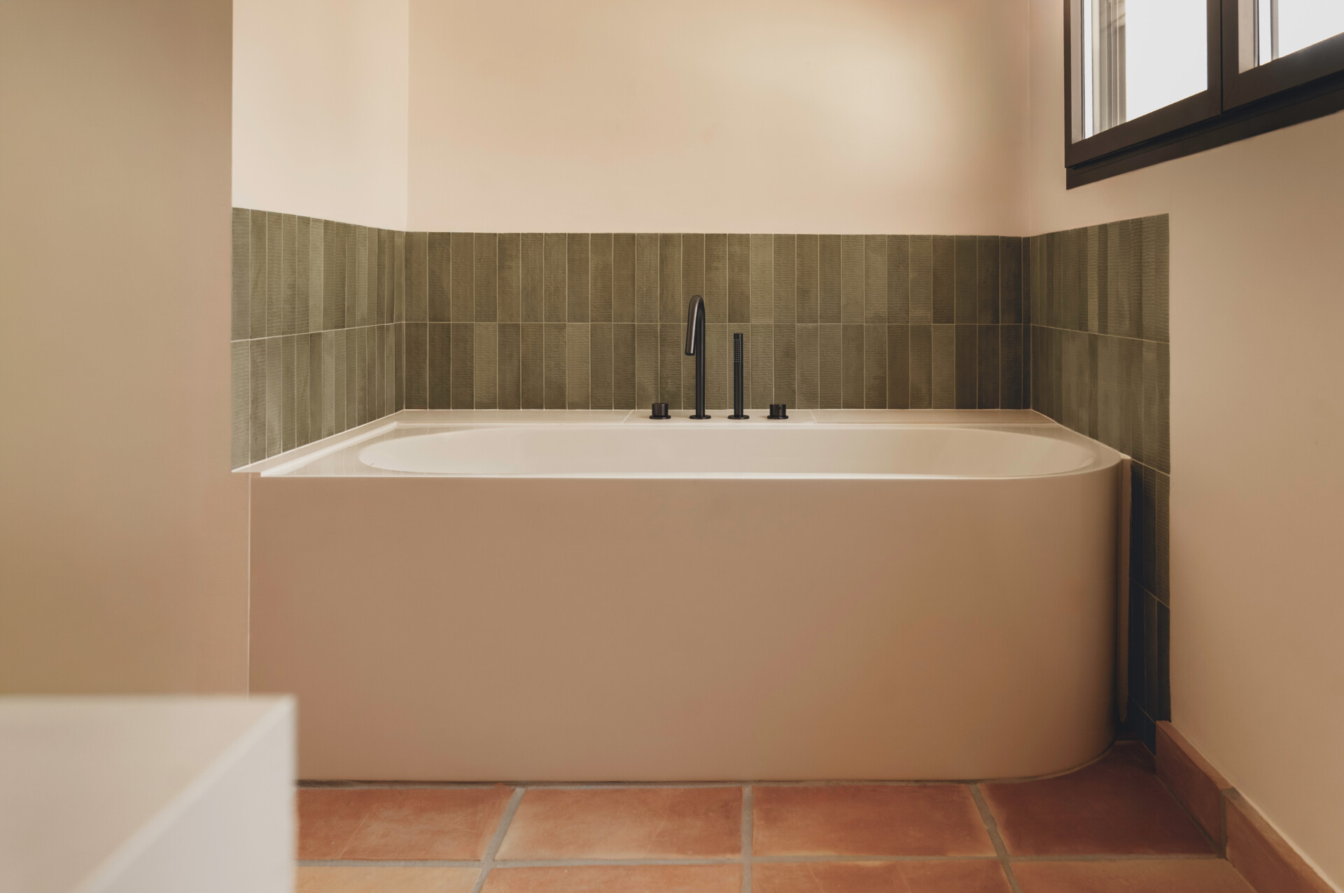 Textured ceramic walls, custom lighting and warm finishes make these Mediterranean bathrooms full of character.