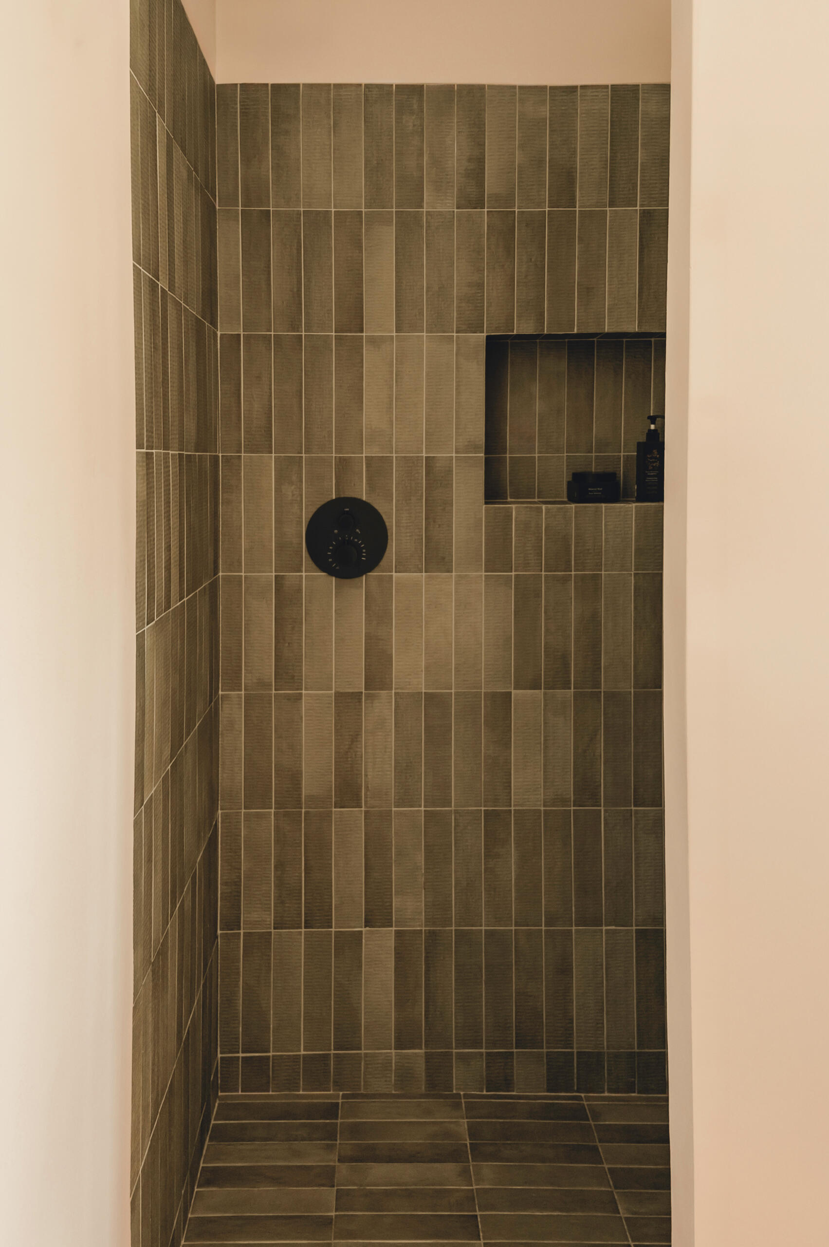 Textured ceramic walls, custom lighting and warm finishes make these Mediterranean bathrooms full of character.